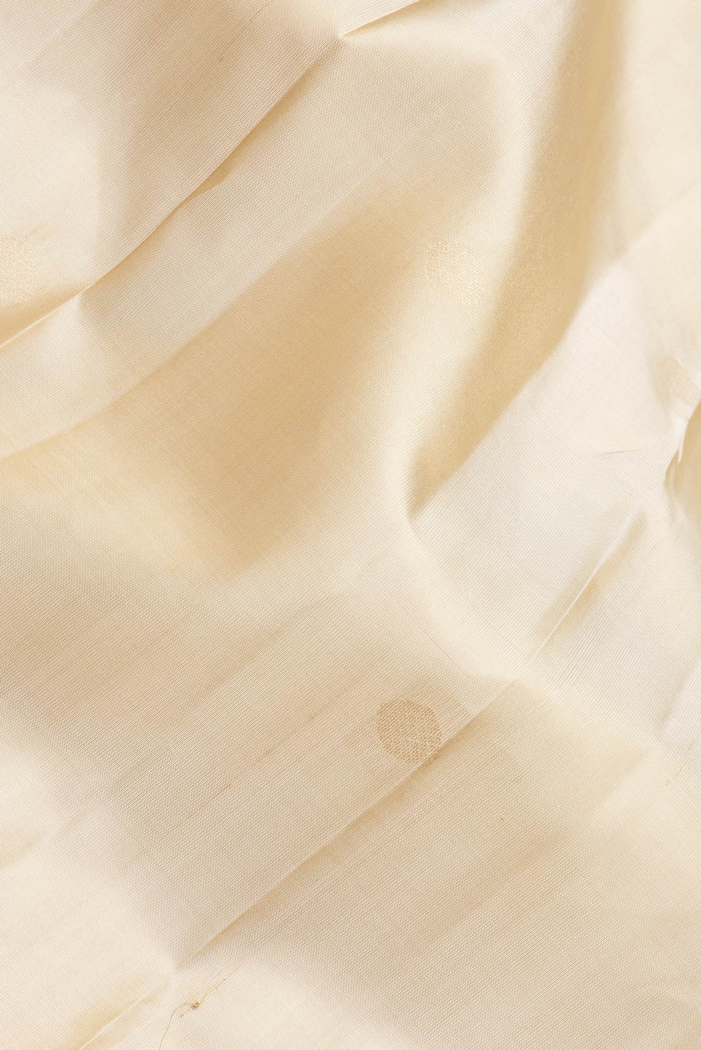 Close up of Dark Beige Dual Tone Kanchipuram Silk Saree with Zari Butta on the body and Zari Border.  displaying folds