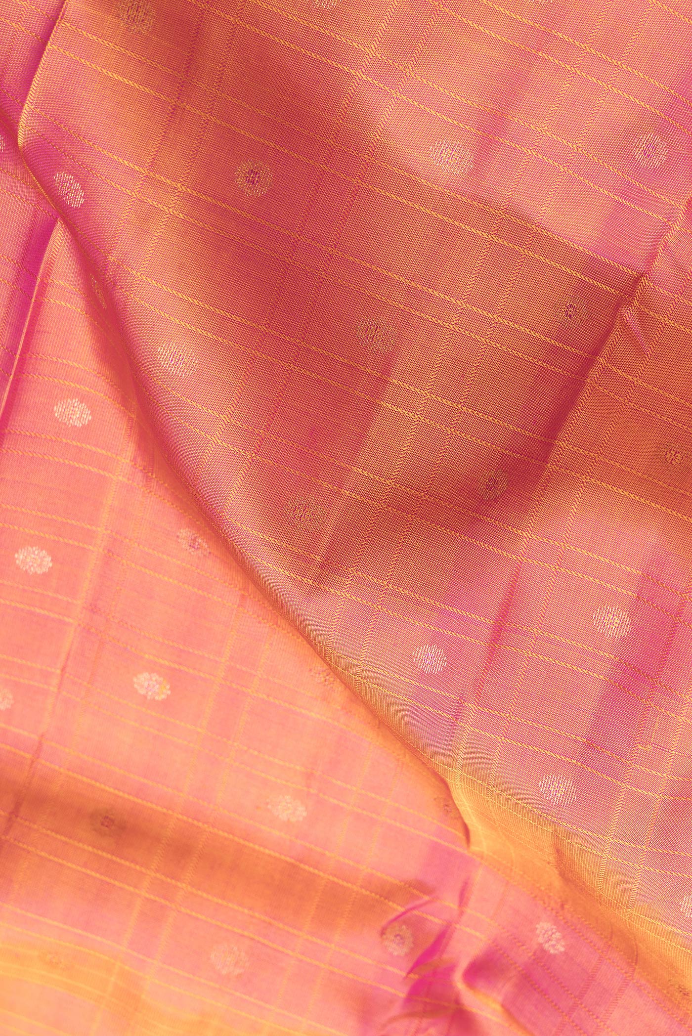 Close up of Coral Dual Tone Kanchipuram Silk Saree with Checked design on the body and Zari Border.  displaying folds