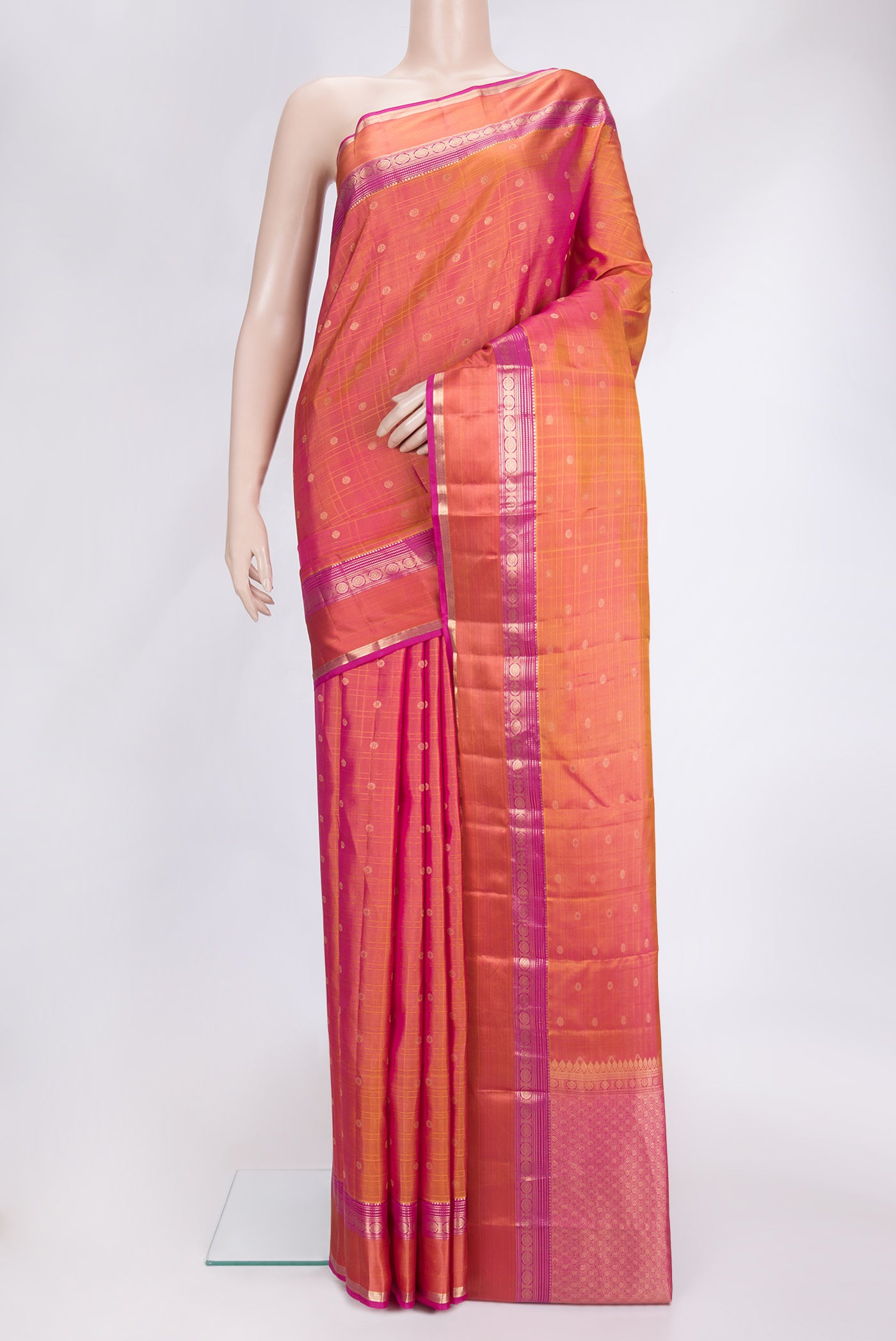 Coral Dual Tone Kanchipuram Silk Saree with Checked design on the body and Zari Border.  displayed on a mannequin