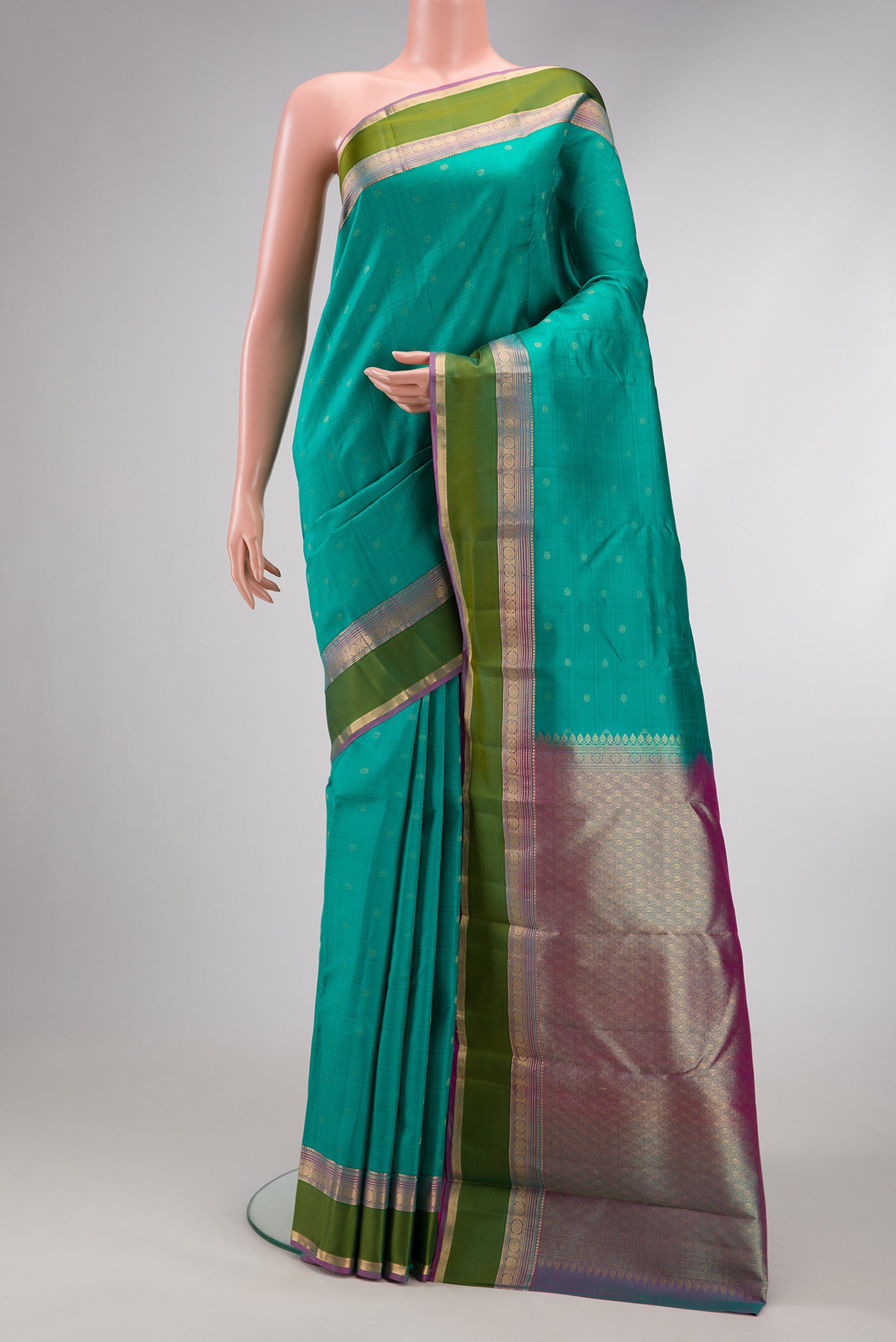 Sea Green Dual Tone Kanchipuram Silk Saree with Zari Butta on the body and Zari Border.  displayed on a mannequin