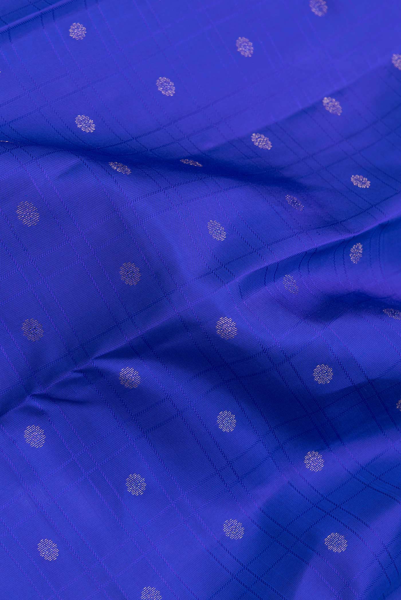 Close up of Royal Blue Dual Tone Kanchipuram Silk Saree with Zari Butta on the body and Zari Border.  displaying folds