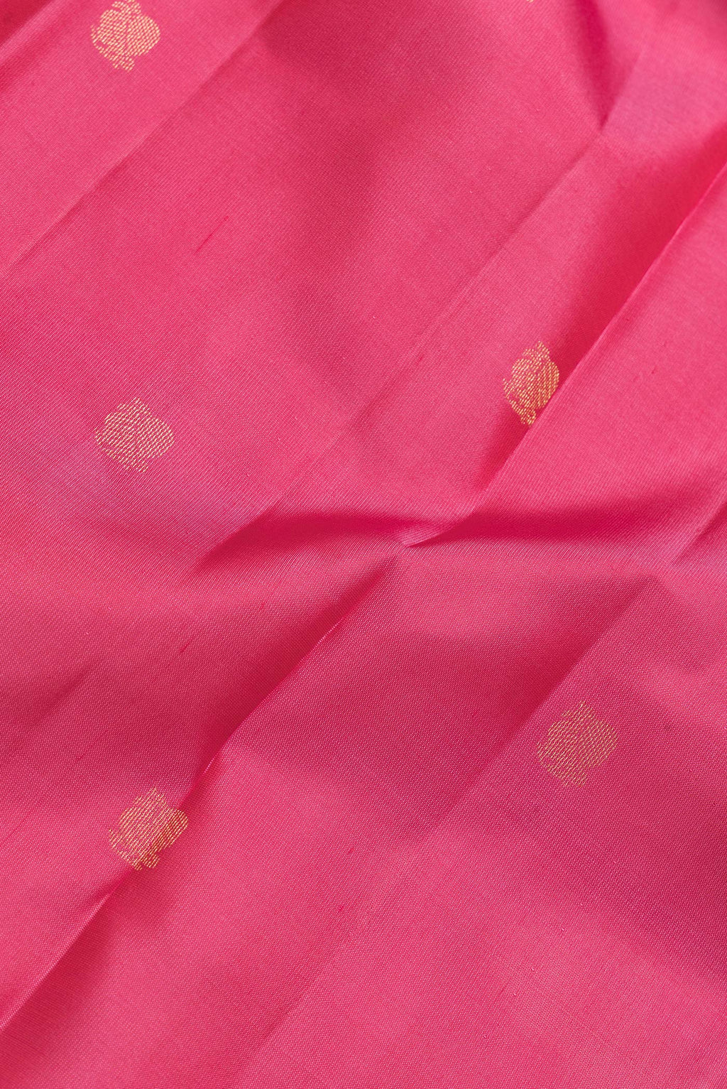 Close up of Pink Dual Tone Kanjivaram Silk Saree with Zari Butta on the body and Zari Border.  displaying folds
