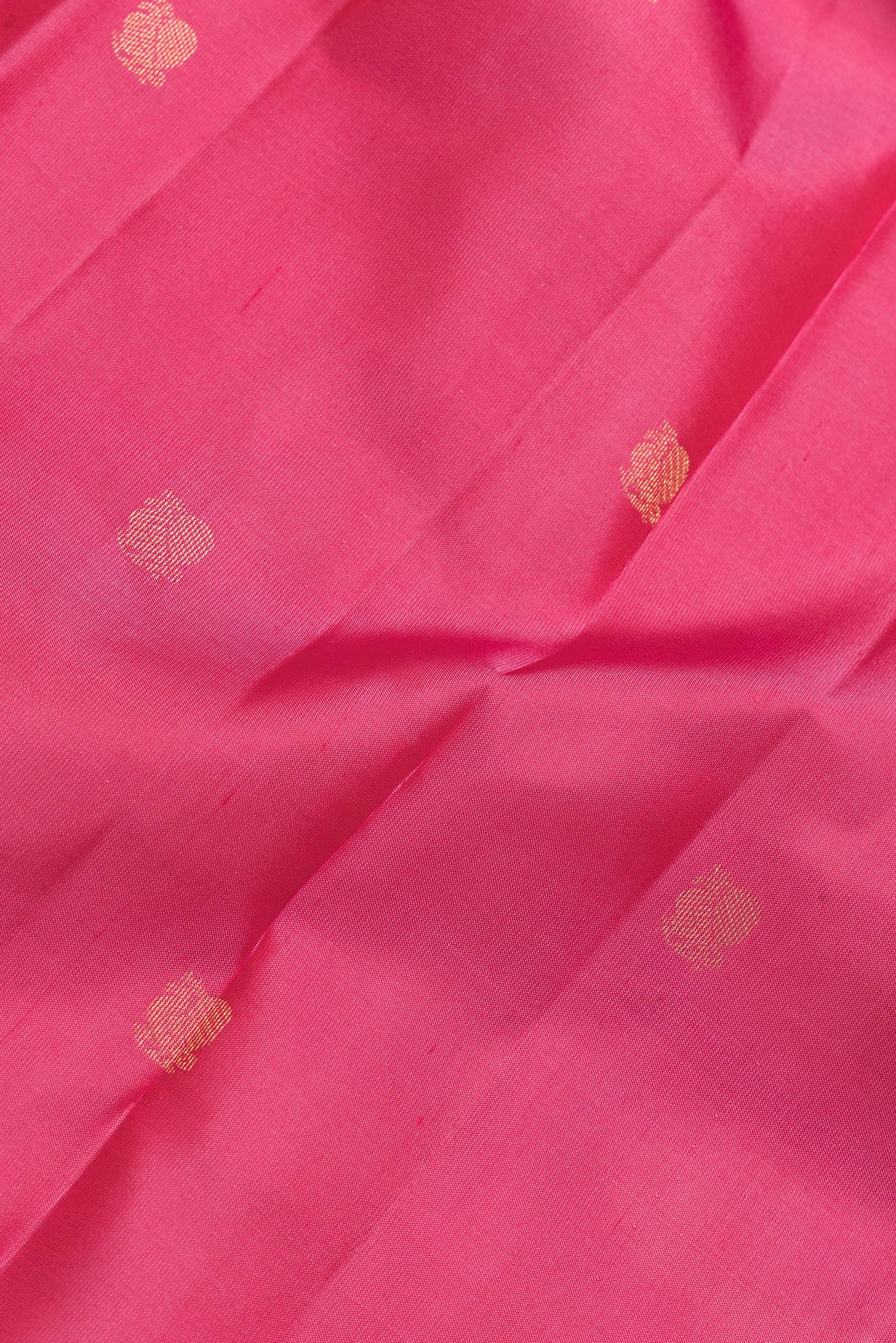 Close up of Pink Dual Tone Kanjivaram Silk Saree with Zari Butta on the body and Zari Border.  displaying folds