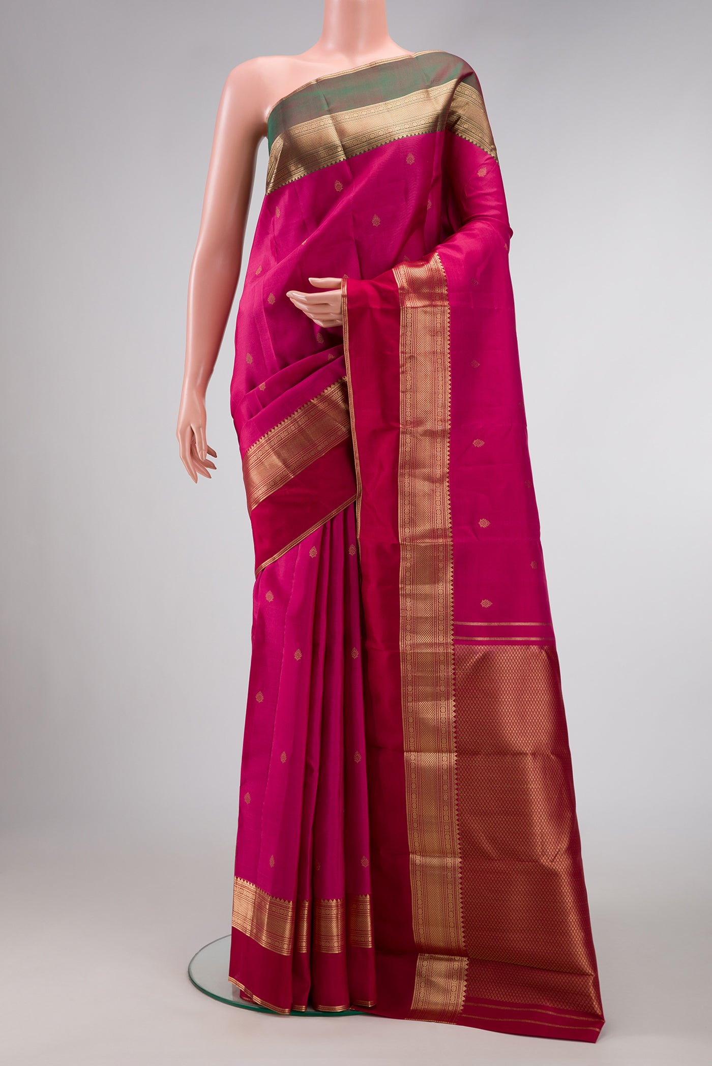 Dark Mauve Dual Tone Kanchipuram Silk Saree with Zari Butta on the body and Ganga Jamuna Border.  displayed on a mannequin