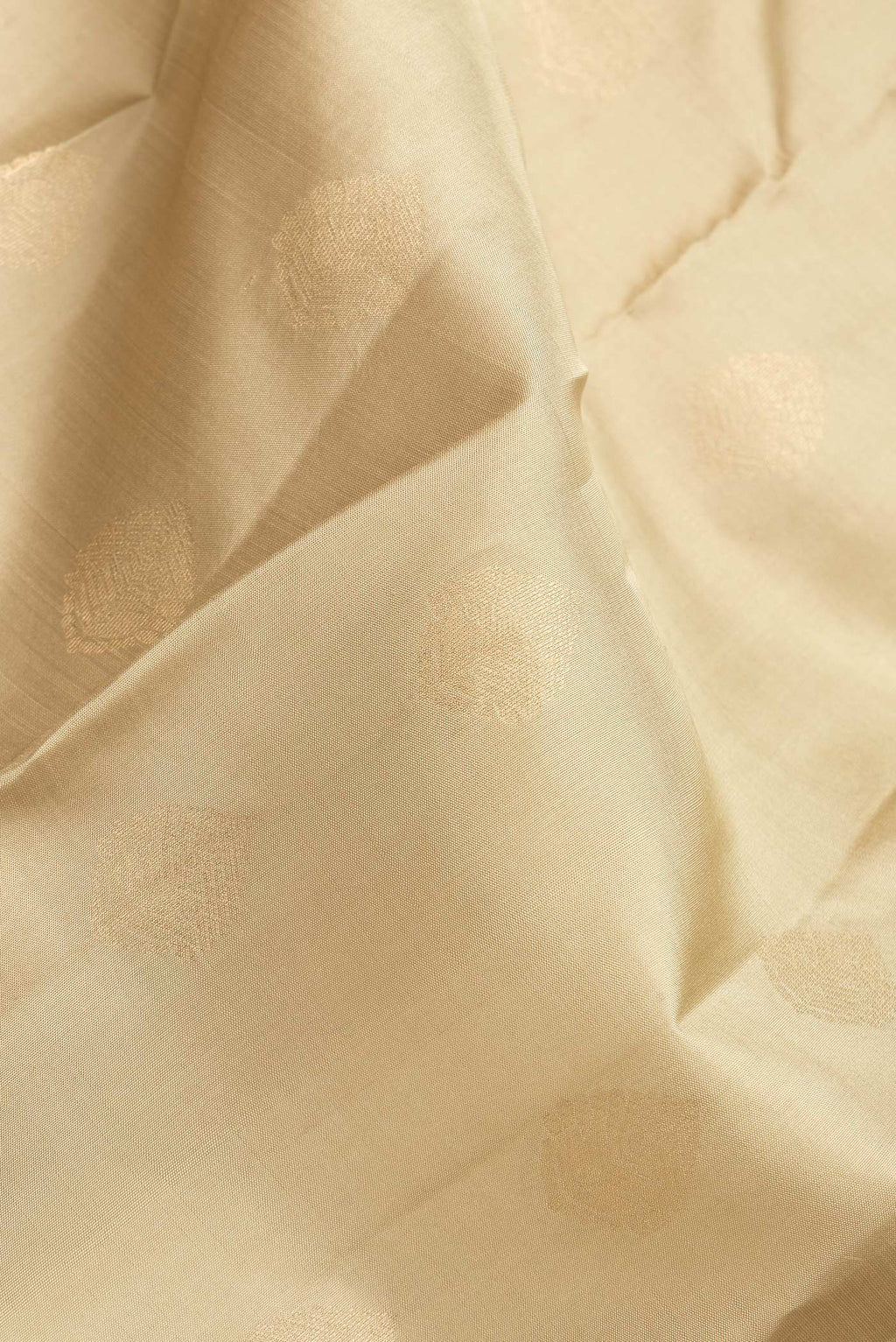 Close up of Dark Beige Dual Tone Kanchipuram Silk Saree with Zari Butta on the body and Zari Border.  displaying folds