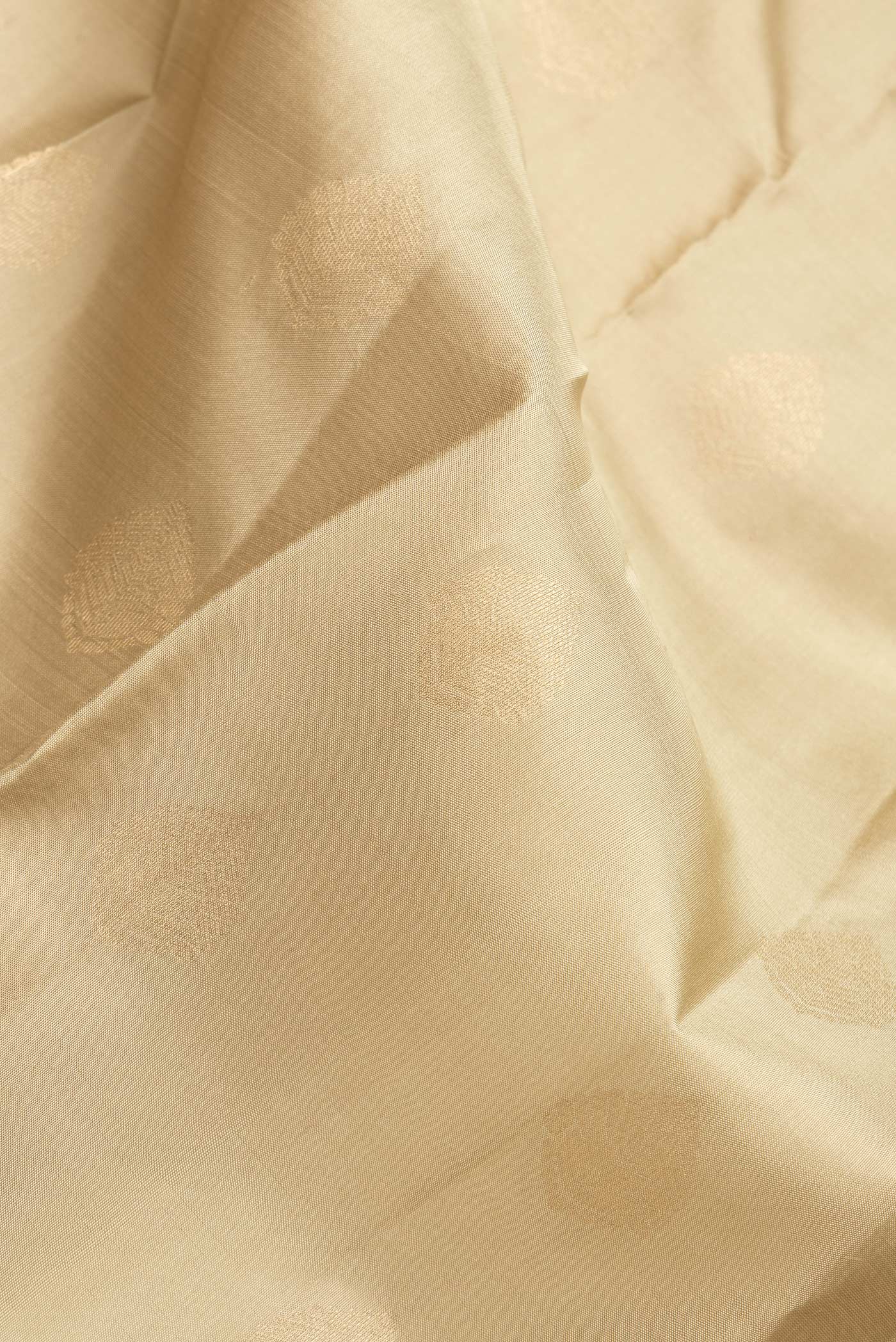 Close up of Dark Beige Dual Tone Kanchipuram Silk Saree with Zari Butta on the body and Zari Border.  displaying folds