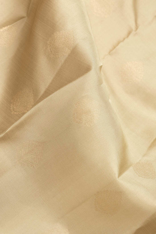 Close up of Dark Beige Dual Tone Kanchipuram Silk Saree with Zari Butta on the body and Zari Border.  displaying folds
