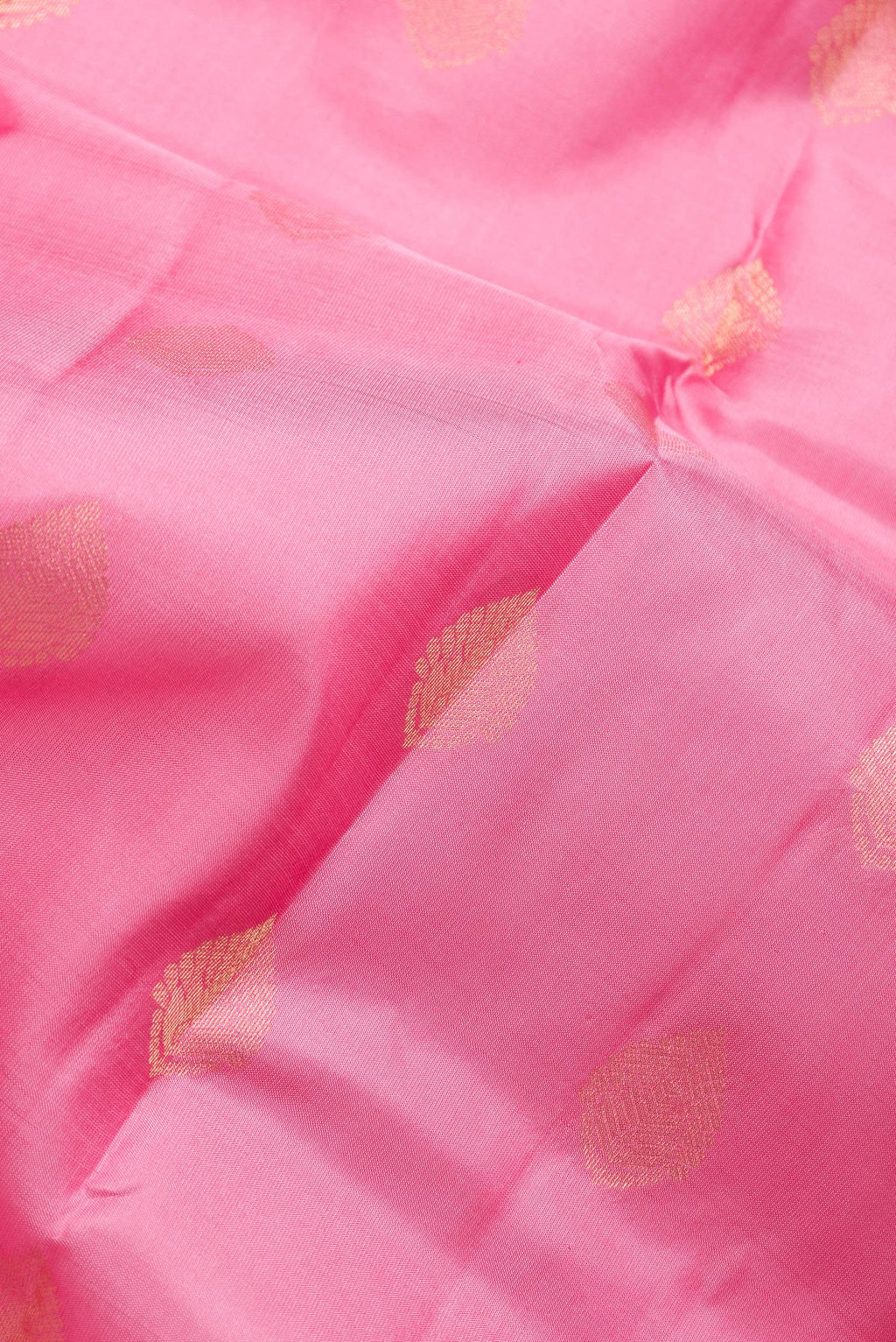 Close up of Pink Dual Tone Kanchipuram Silk Saree with Zari Butta on the body and Zari Border.  displaying folds