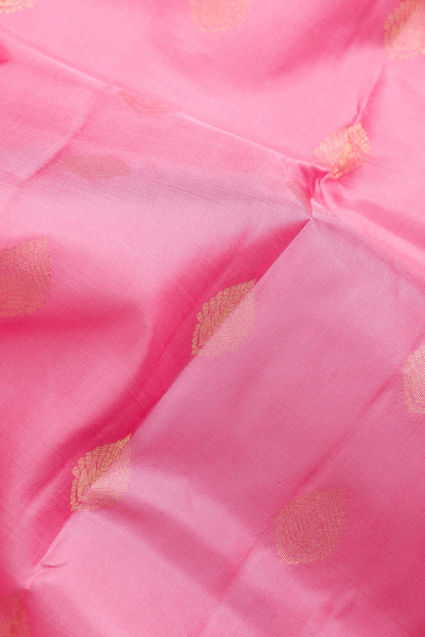 Close up of Pink Dual Tone Kanchipuram Silk Saree with Zari Butta on the body and Zari Border.  displaying folds