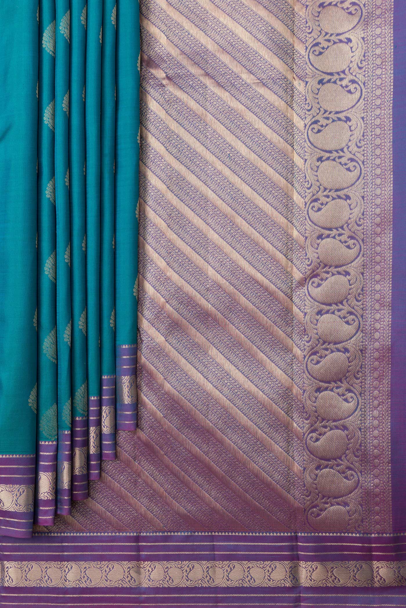 Pleats and pallu of Peacock Blue Dual Tone Kanchipuram Silk Saree with Zari Butta on the body and Zari Border. 