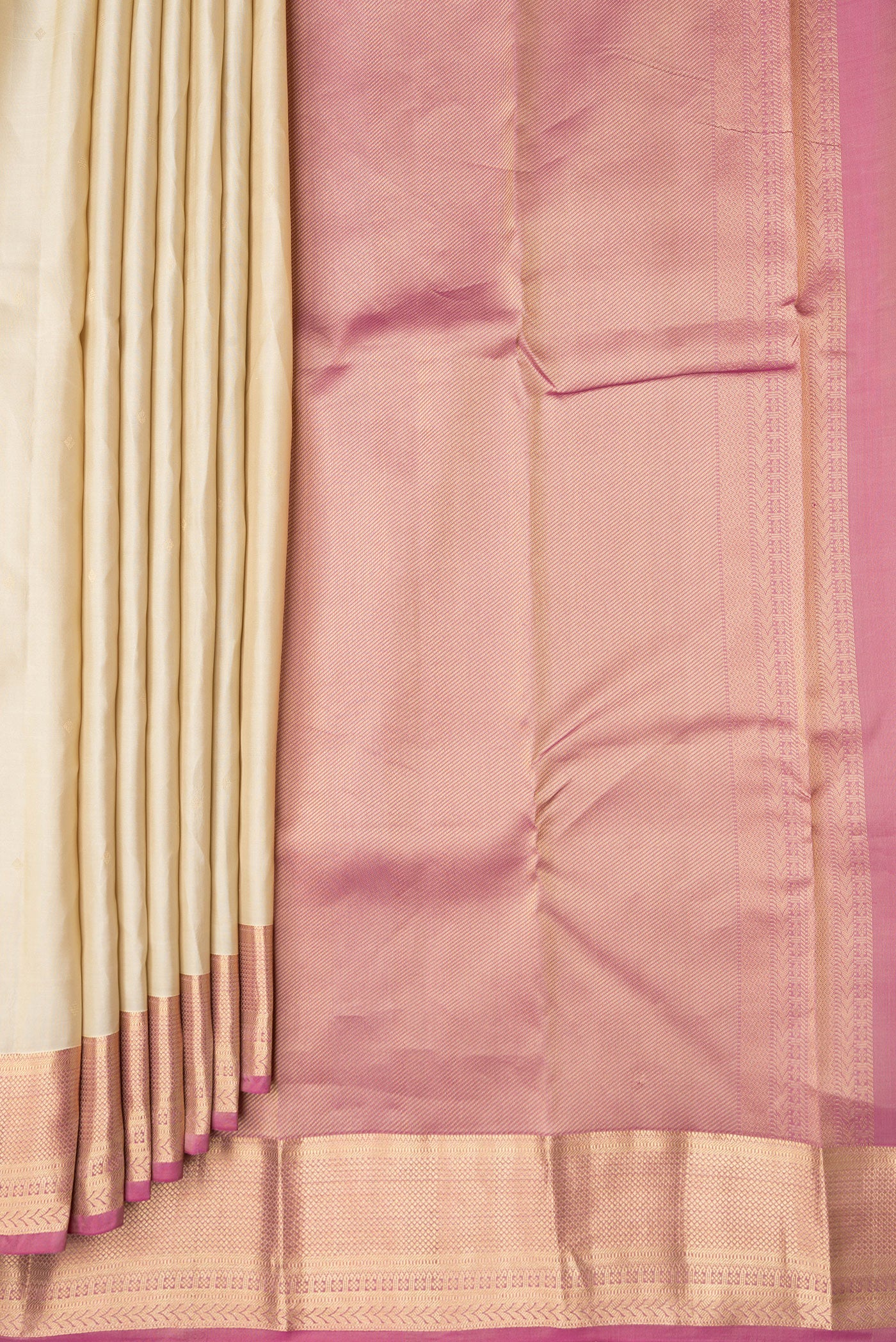 Pleats and pallu of Beige Dual Tone Kanchipuram Silk Saree with Zari Butta on the body and Fancy Border. 