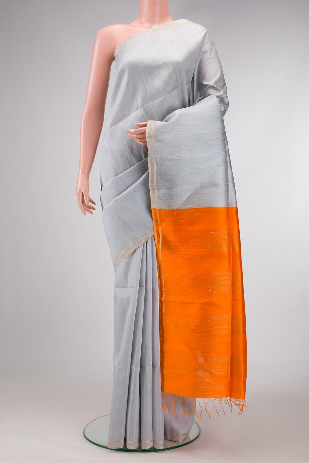 Grey Dual Tone Raw Silk Saree with Plain Body and Zari Border.  displayed on a mannequin