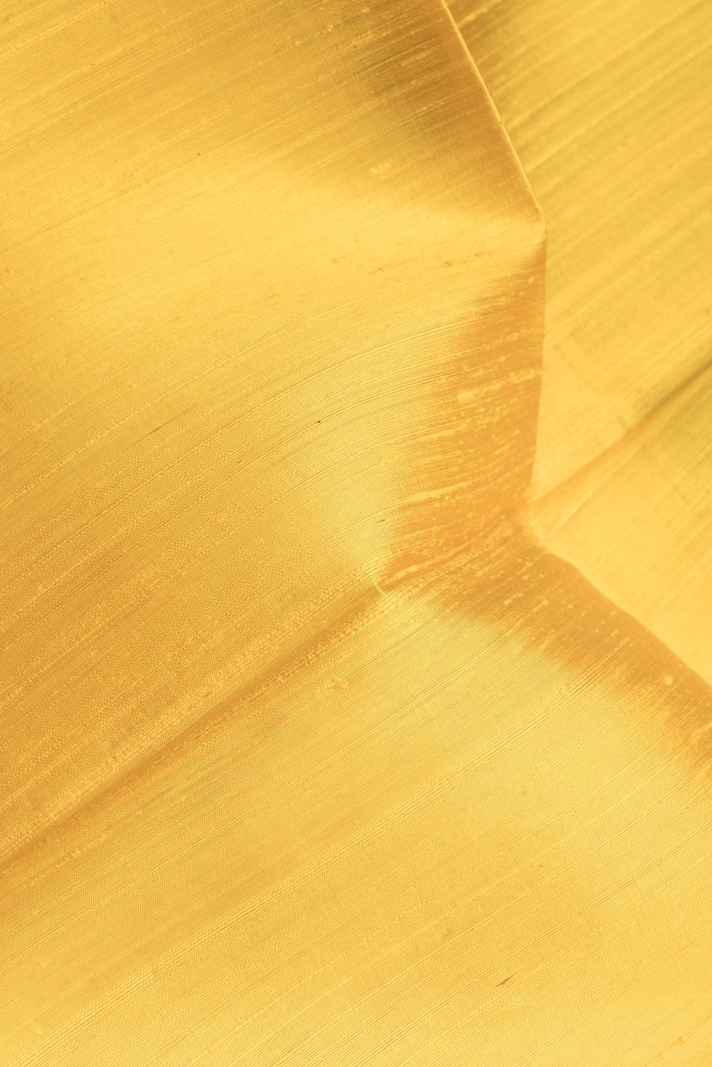 Close up of Yellow Dual Tone Raw Silk Saree with Plain Body and Zari Border.  displaying folds