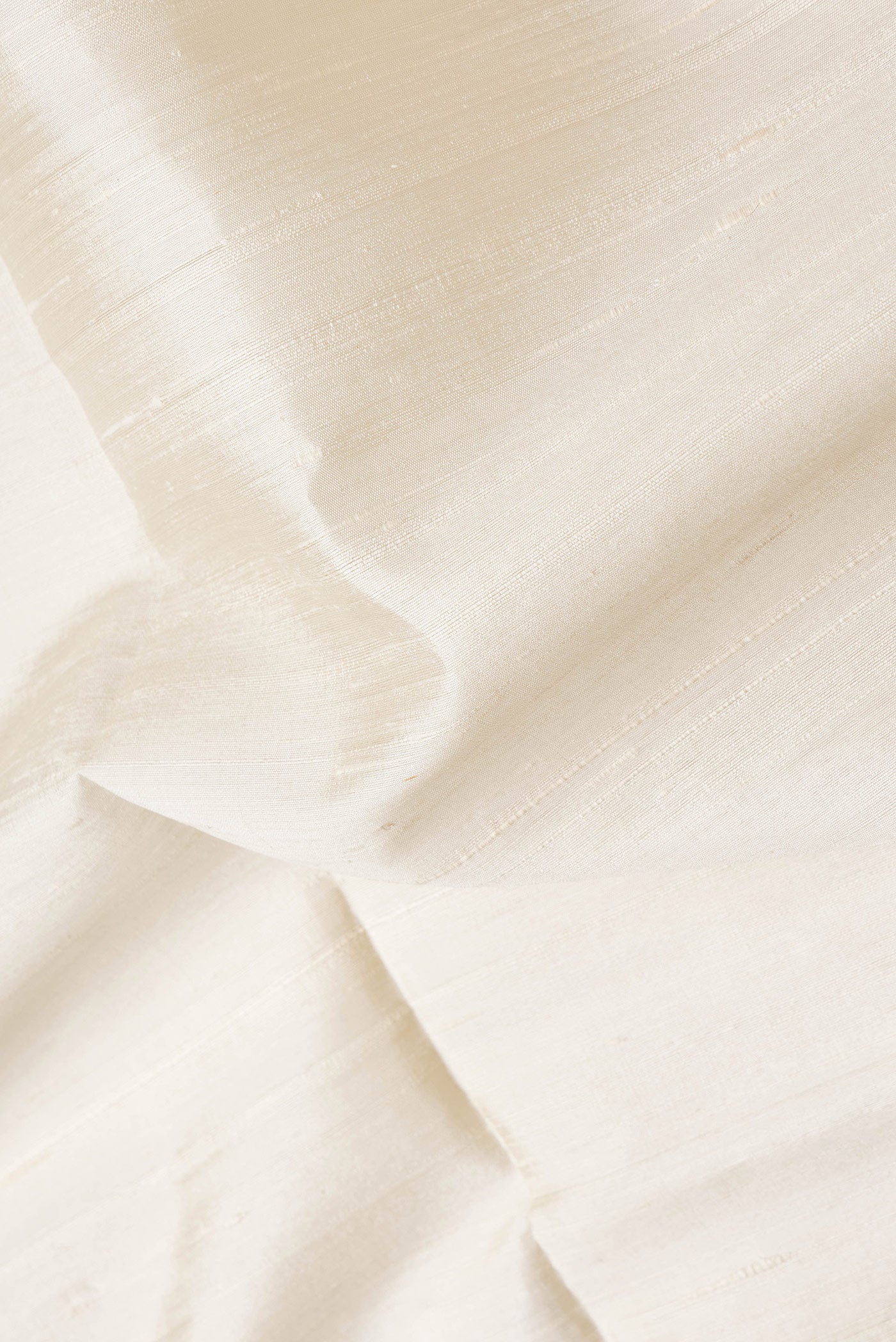 Close up of Beige Dual Tone Raw Silk Saree with Plain Body and Thin Zari Line.  displaying folds