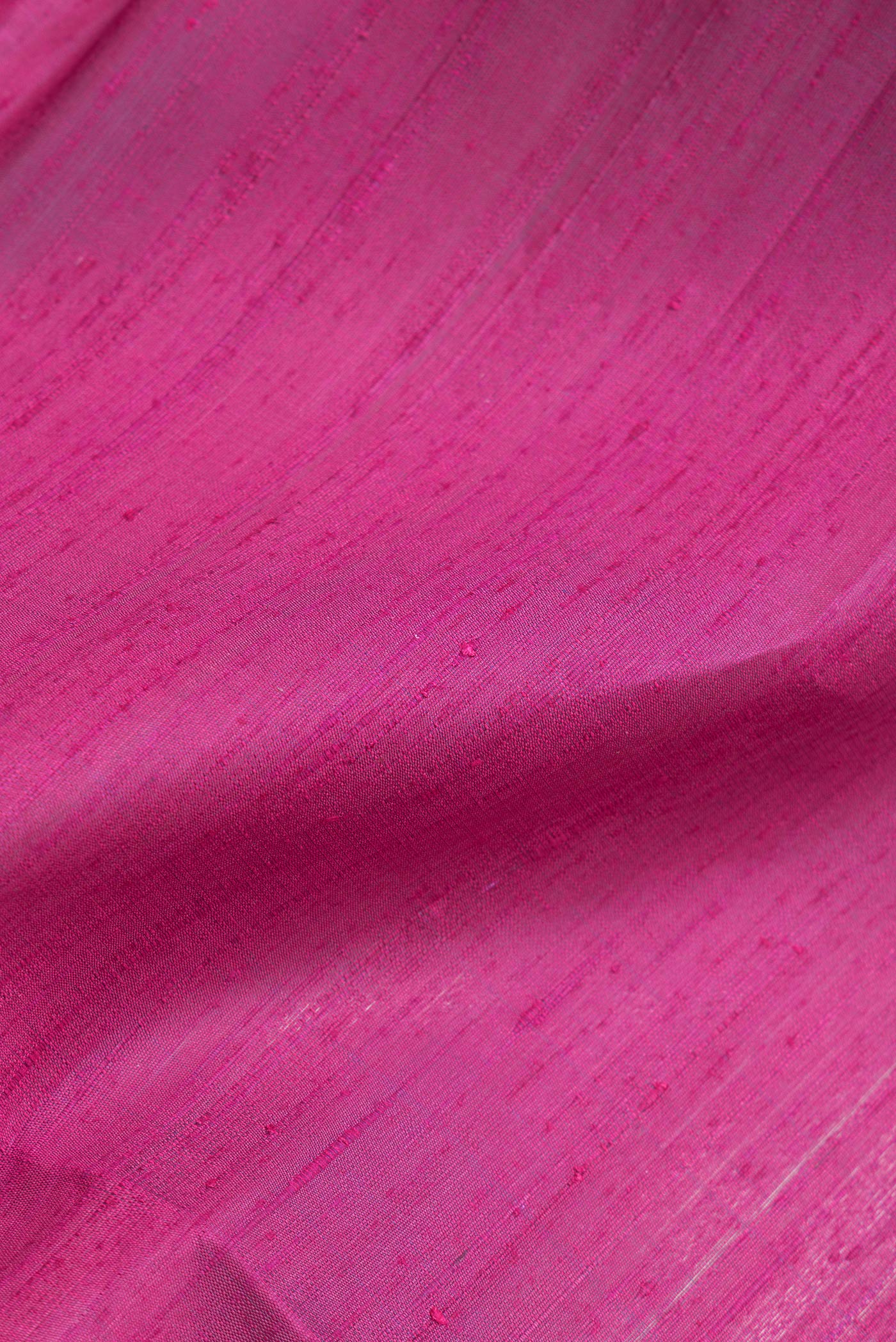Close up of Dark Pink Dual Tone Banarasi Raw Silk Saree with Plain Body and Zari Border.  displaying folds