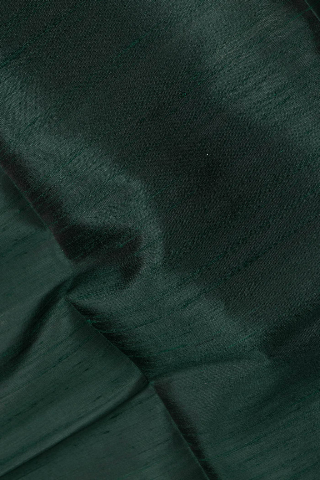 Close up of Bottle Green Dual Tone Raw Silk Saree with Plain Body and Zari Border.  displaying folds