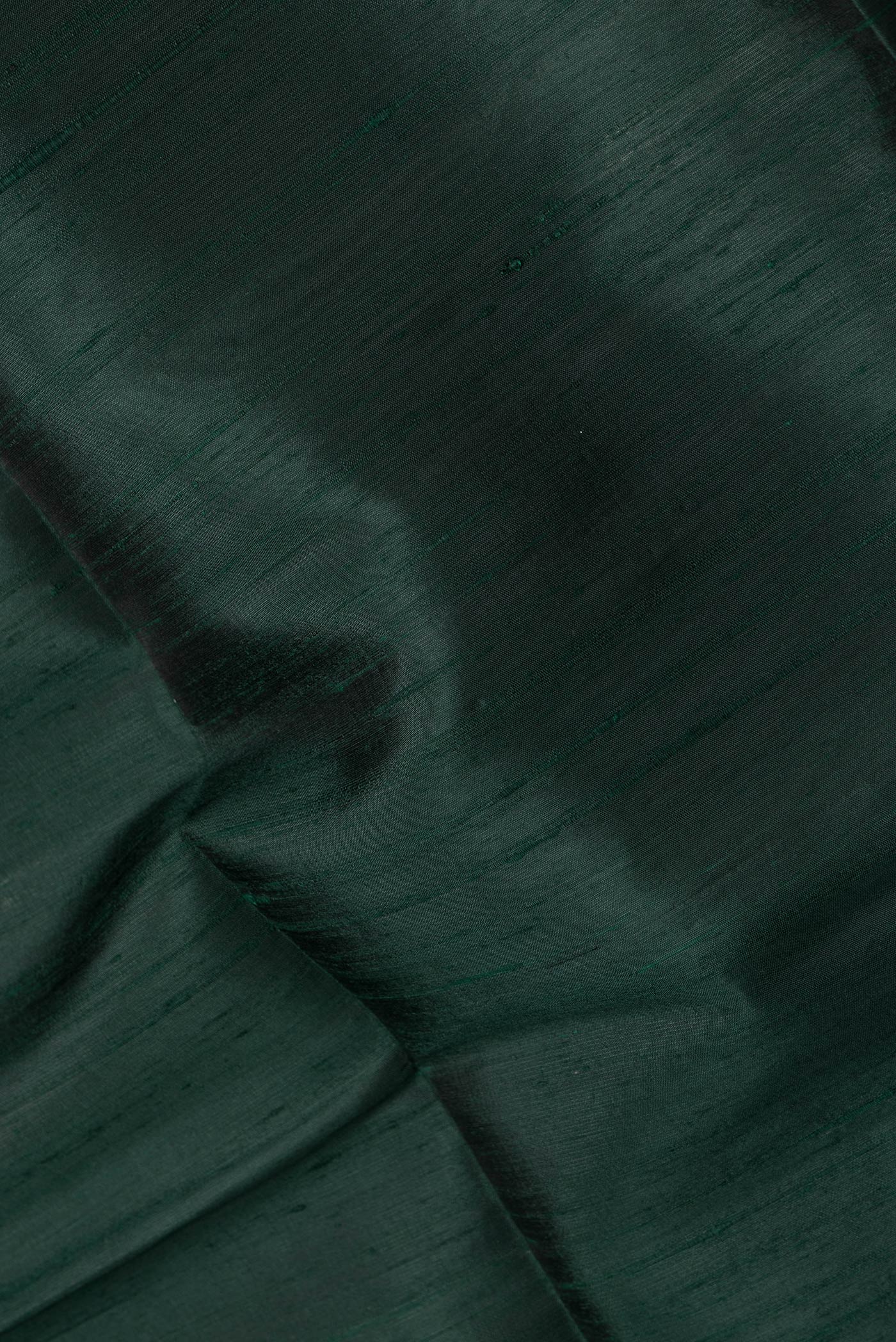 Close up of Bottle Green Dual Tone Raw Silk Saree with Plain Body and Zari Border.  displaying folds