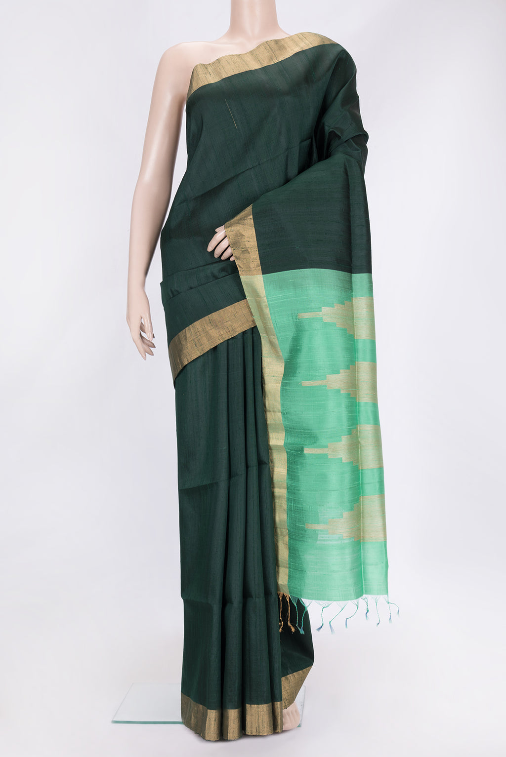 Bottle Green Dual Tone Raw Silk Saree with Plain Body and Zari Border.  displayed on a mannequin