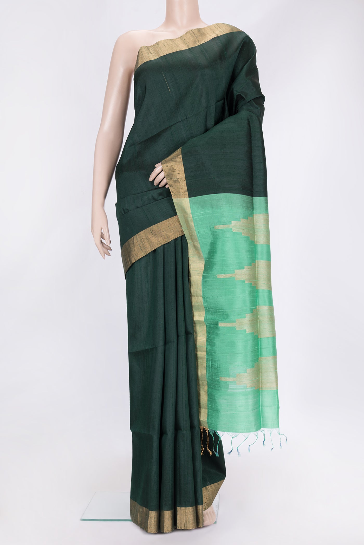 Bottle Green Dual Tone Raw Silk Saree with Plain Body and Zari Border.  displayed on a mannequin