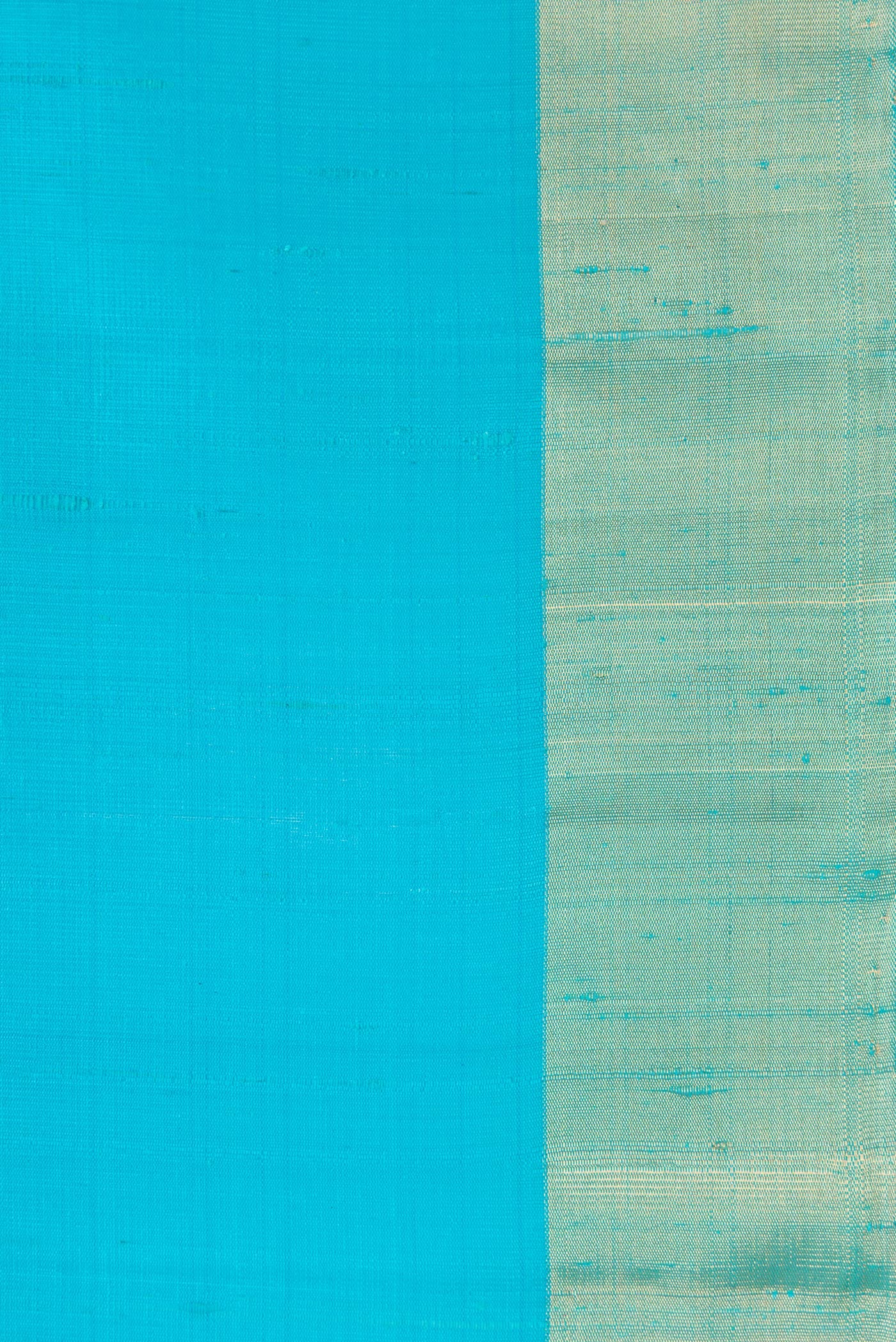 Border image of Sky Blue Dual Tone Raw Silk Saree with Plain Body and Zari Border. 