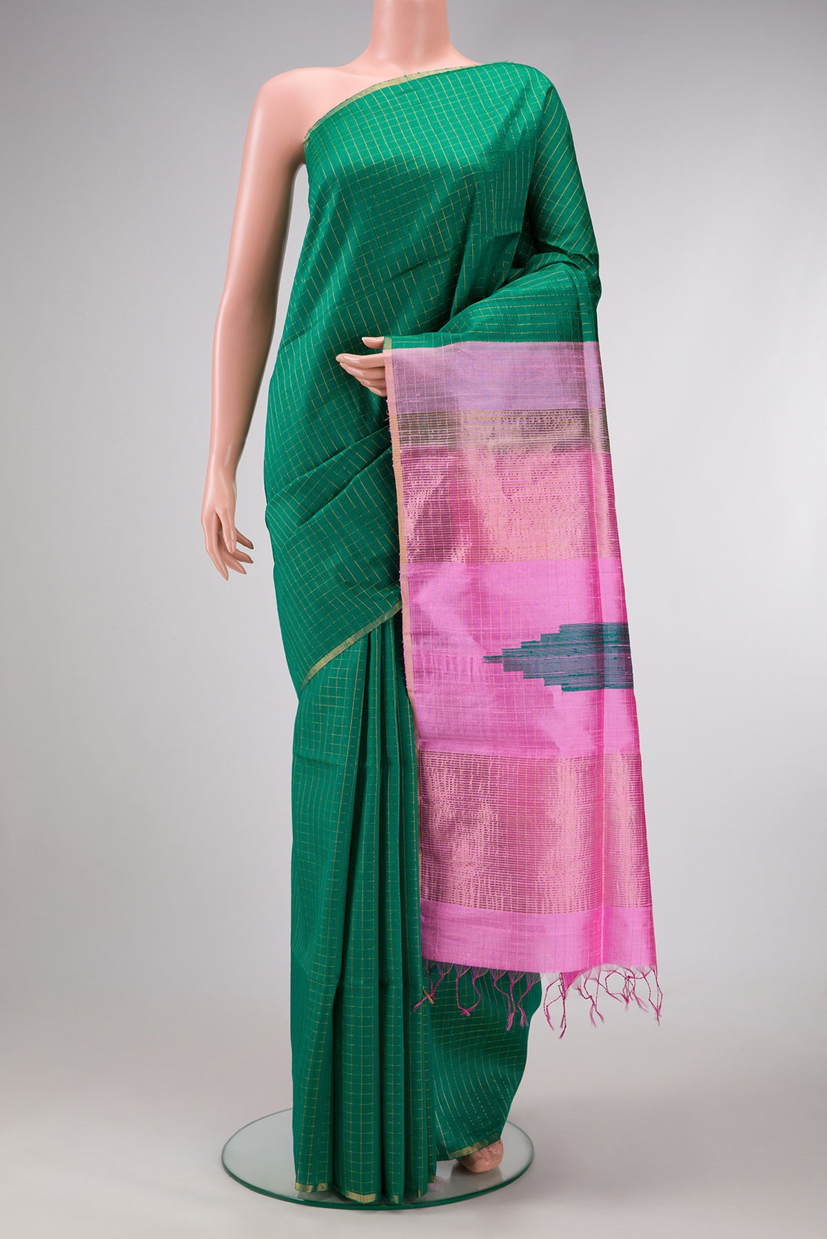 Green Dual Tone Raw Silk Saree with Checked design on the body and Thin Zari Line.  displayed on a mannequin
