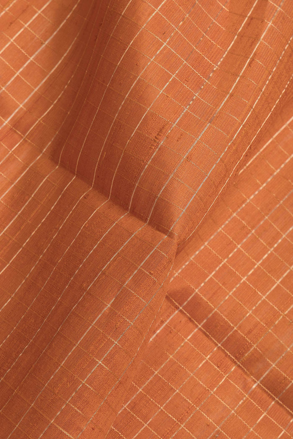 Close up of Bronze Dual Tone Raw Silk Saree with Checked design on the body and Thin Zari Line.  displaying folds