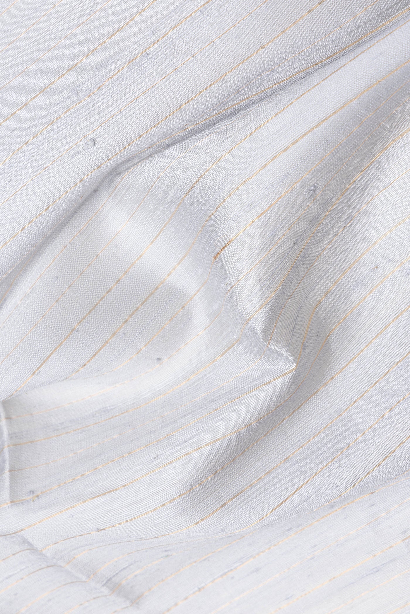 Close up of Grey Dual Tone Raw Silk Saree with Stripes on the body and Temple Border.  displaying folds