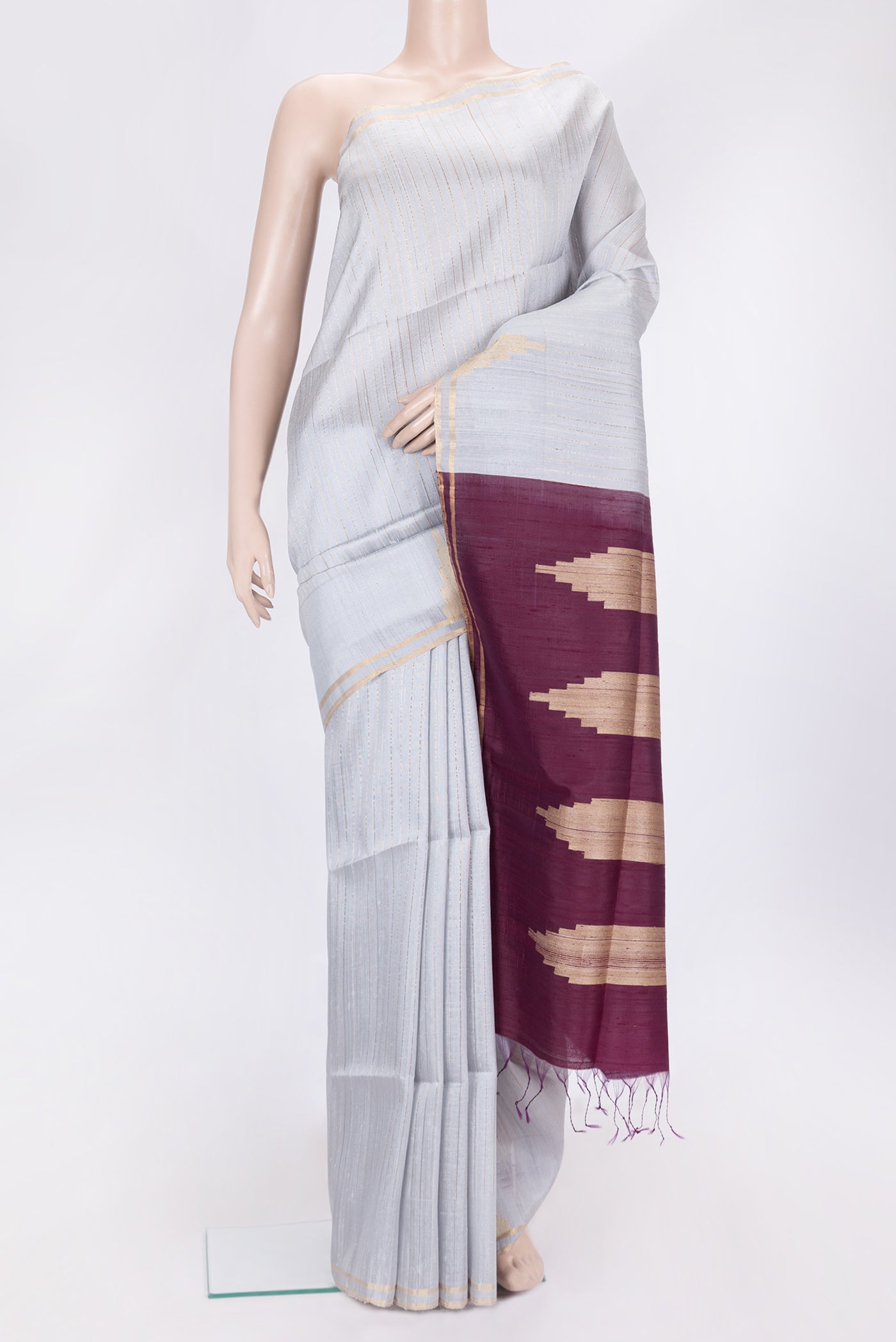 Grey Dual Tone Raw Silk Saree with Stripes on the body and Temple Border.  displayed on a mannequin