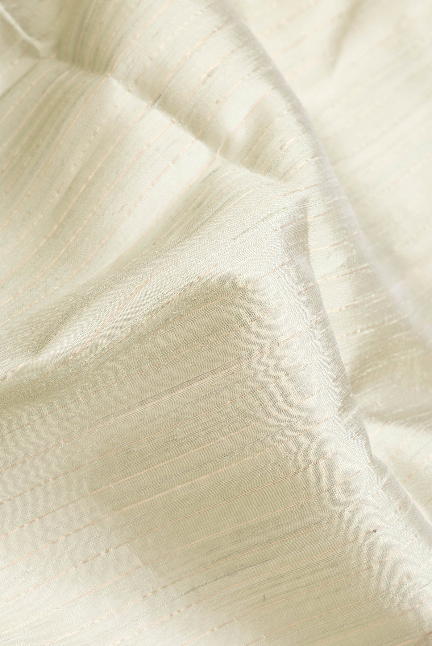 Close up of Grey Dual Tone Raw Silk Saree with Stripes on the body and Temple Border.  displaying folds