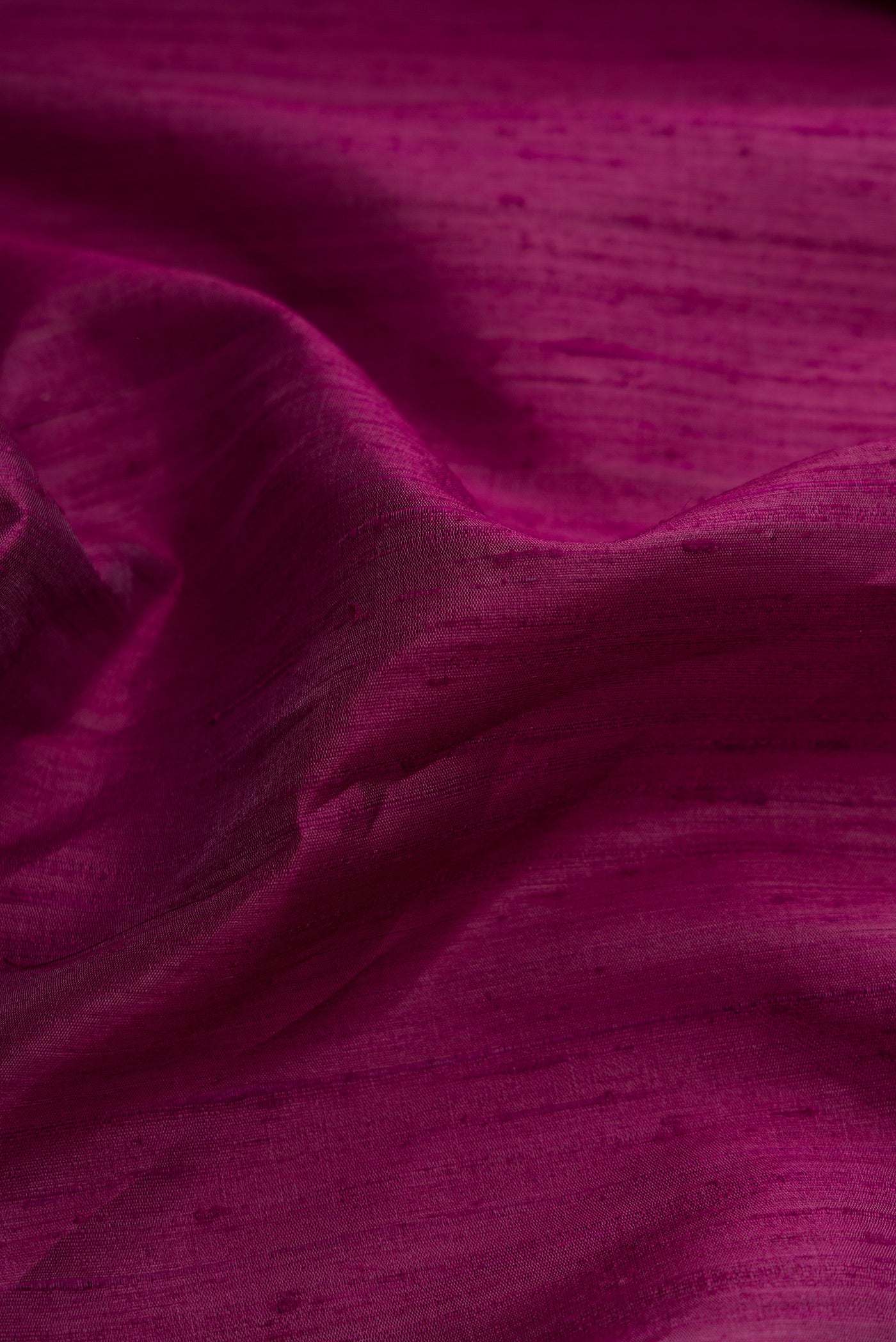 Close up of Burgundy Dual Tone Raw Silk Saree with Stripes on the body and Thin Zari Line.  displaying folds