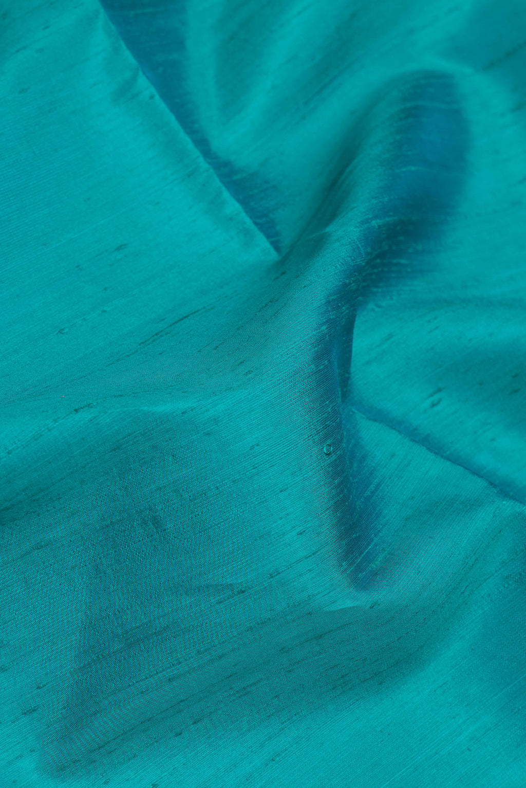 Close up of Sky Blue Dual Tone Raw Silk Saree with Plain Body and Zari Border.  displaying folds