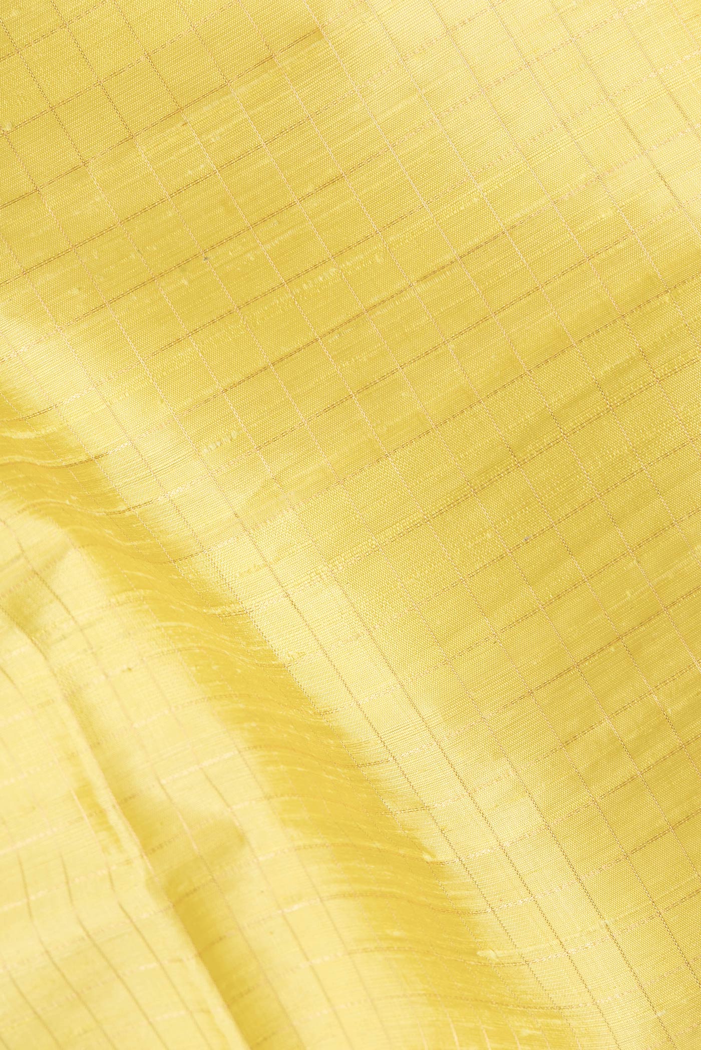 Close up of Lemon Yellow Dual Tone Raw Silk Saree with Checked design on the body and Zari Border.  displaying folds
