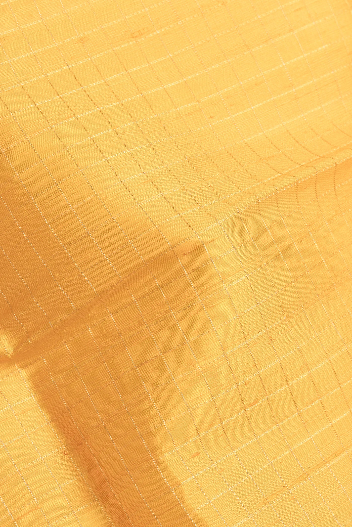 Close up of Yellow Dual Tone Raw Silk Saree with Checked design on the body and Zari Border.  displaying folds