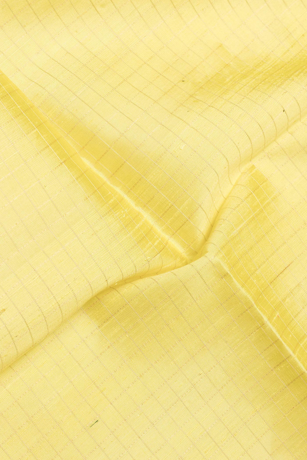 Close up of Yellow Dual Tone Raw Silk Saree with Checked design on the body and Zari Border.  displaying folds