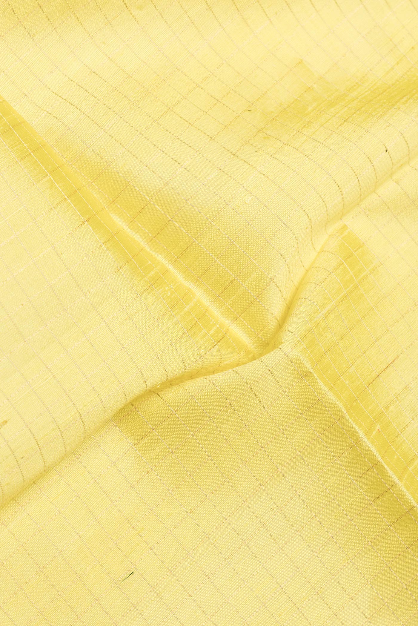 Close up of Yellow Dual Tone Raw Silk Saree with Checked design on the body and Zari Border.  displaying folds
