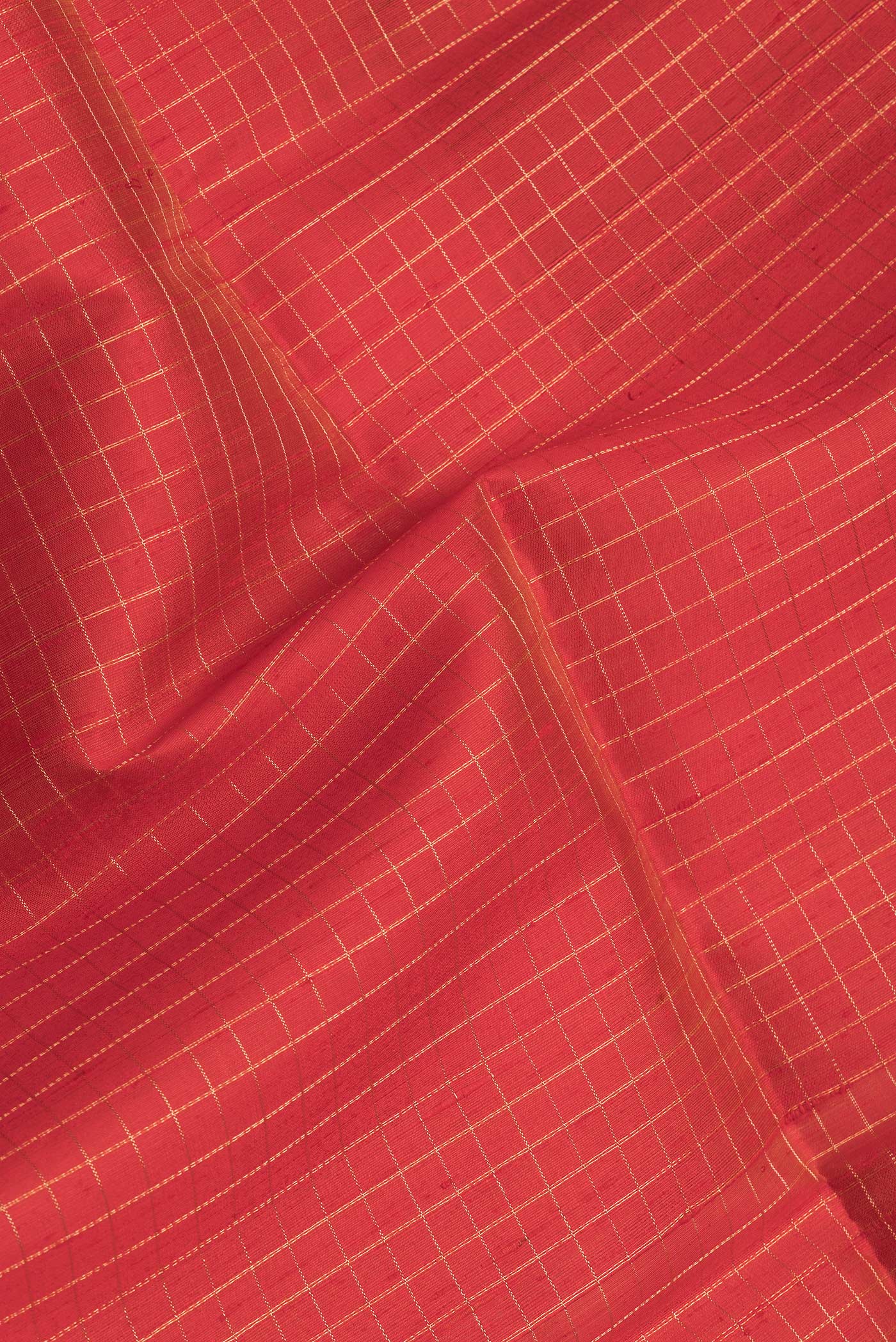 Close up of Red Dual Tone Raw Silk Saree with Checked design on the body and Zari Border.  displaying folds