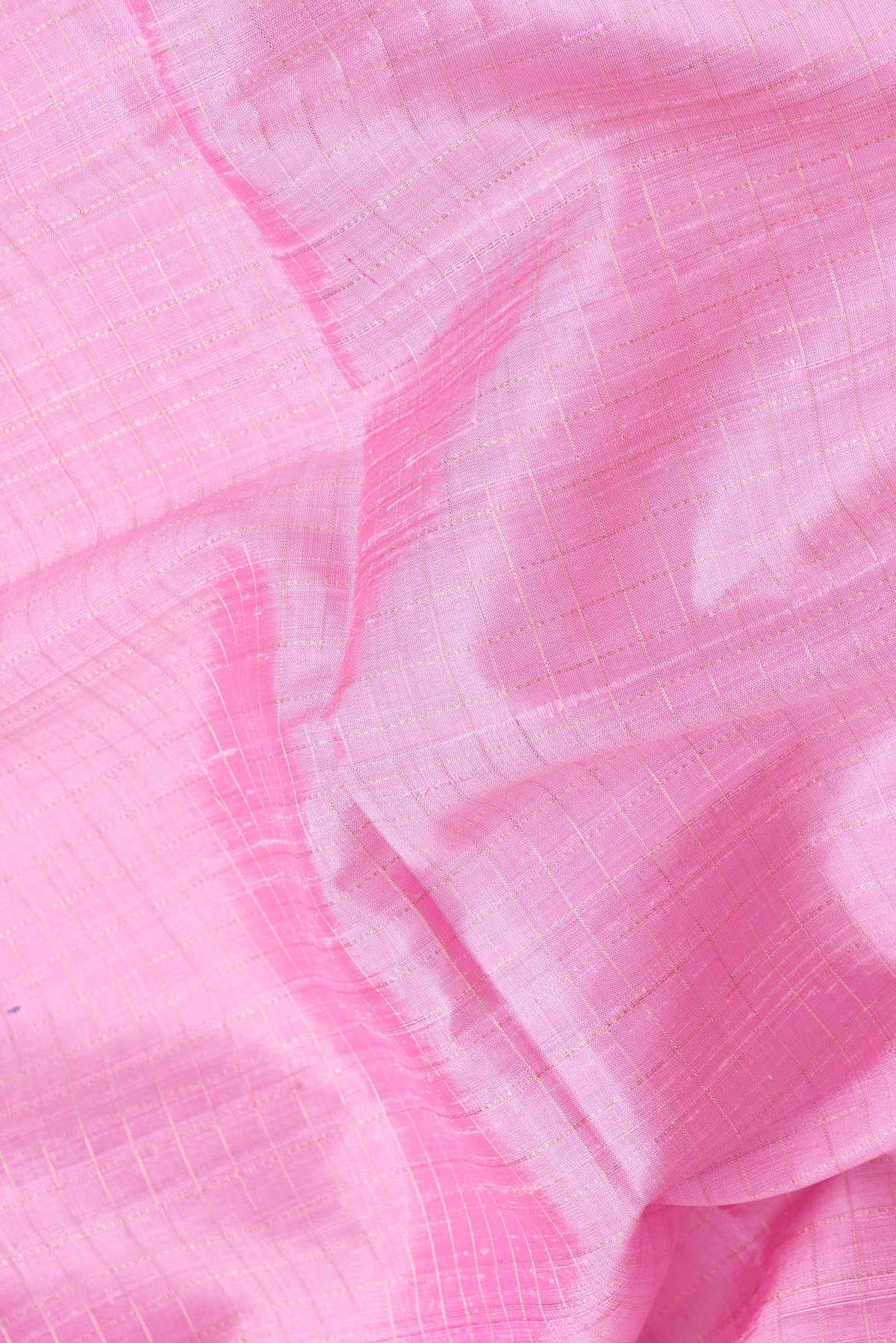 Close up of Pink Dual Tone Raw Silk Saree with Checked design on the body and Thin Zari Line.  displaying folds