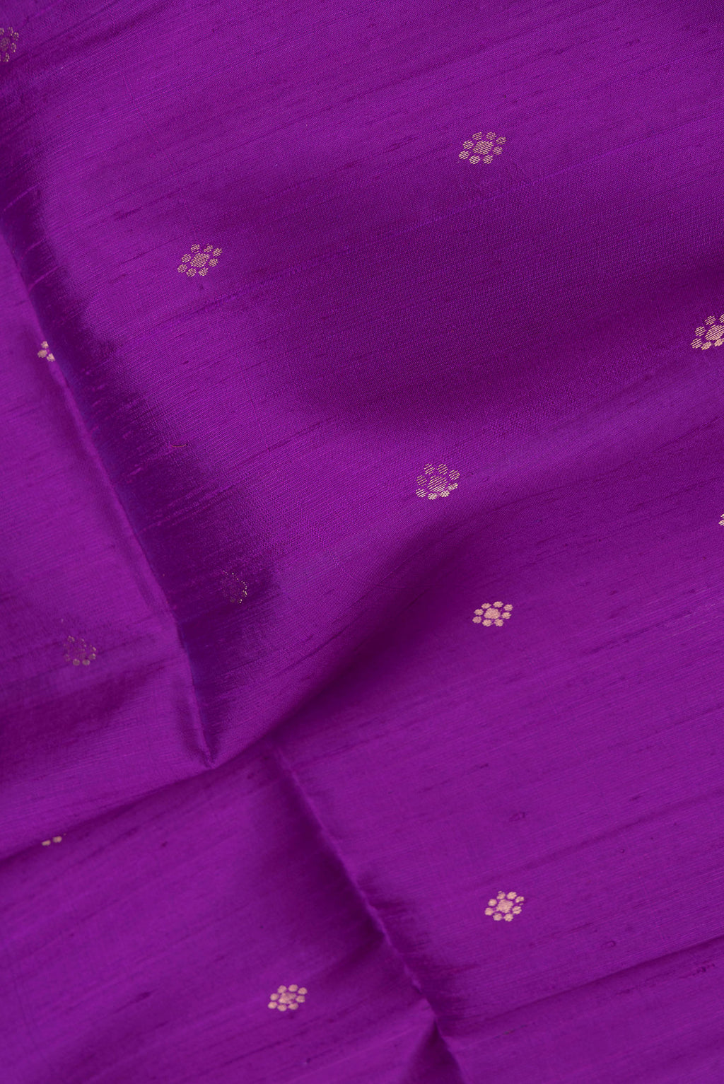 Close up of Peacock Blue Dual Tone Raw Silk Saree with Zari Butta on the body and Thin Zari Line.  displaying folds