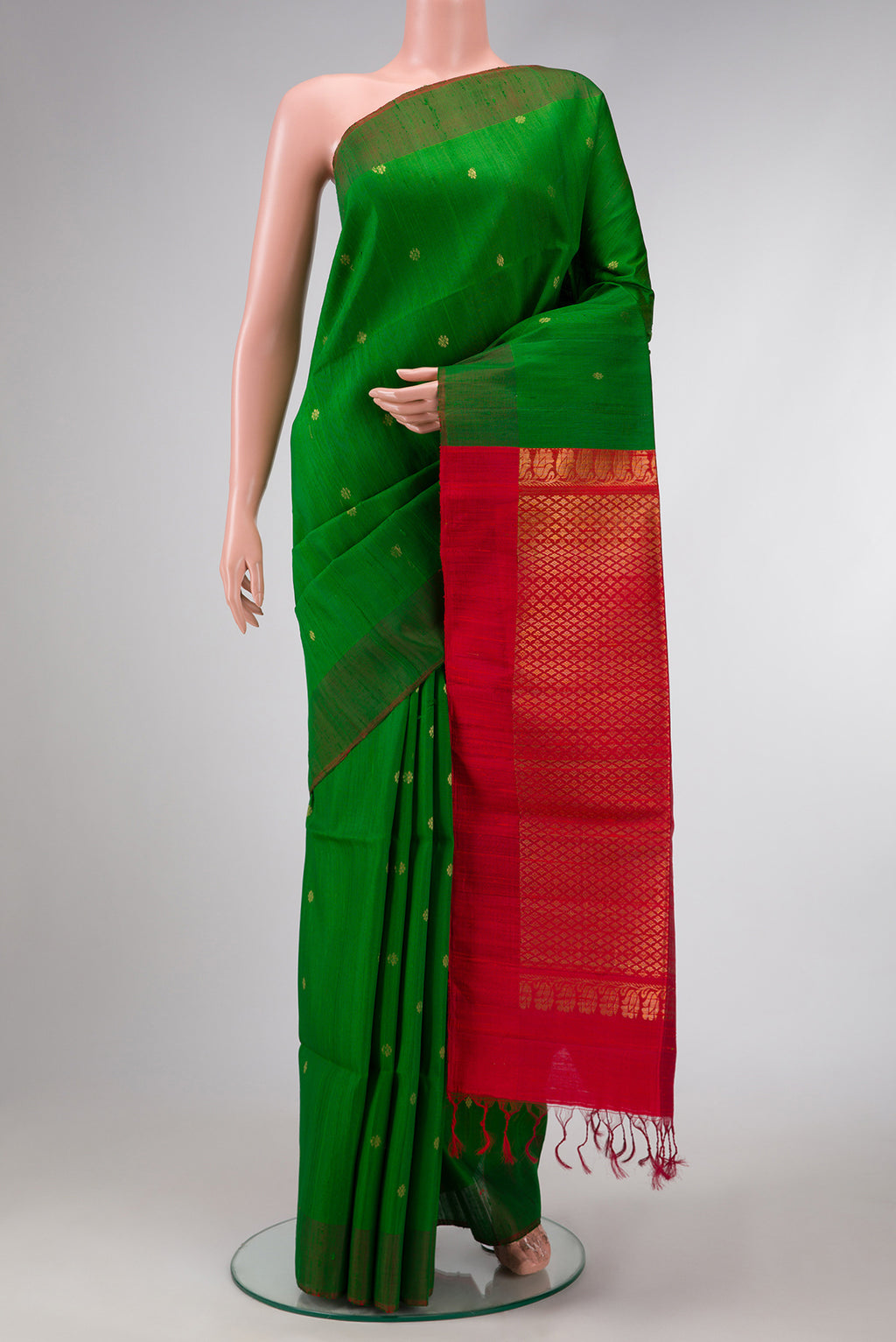 Green Dual Tone Raw Silk Saree with Zari Butta on the body and Plain Border.  displayed on a mannequin