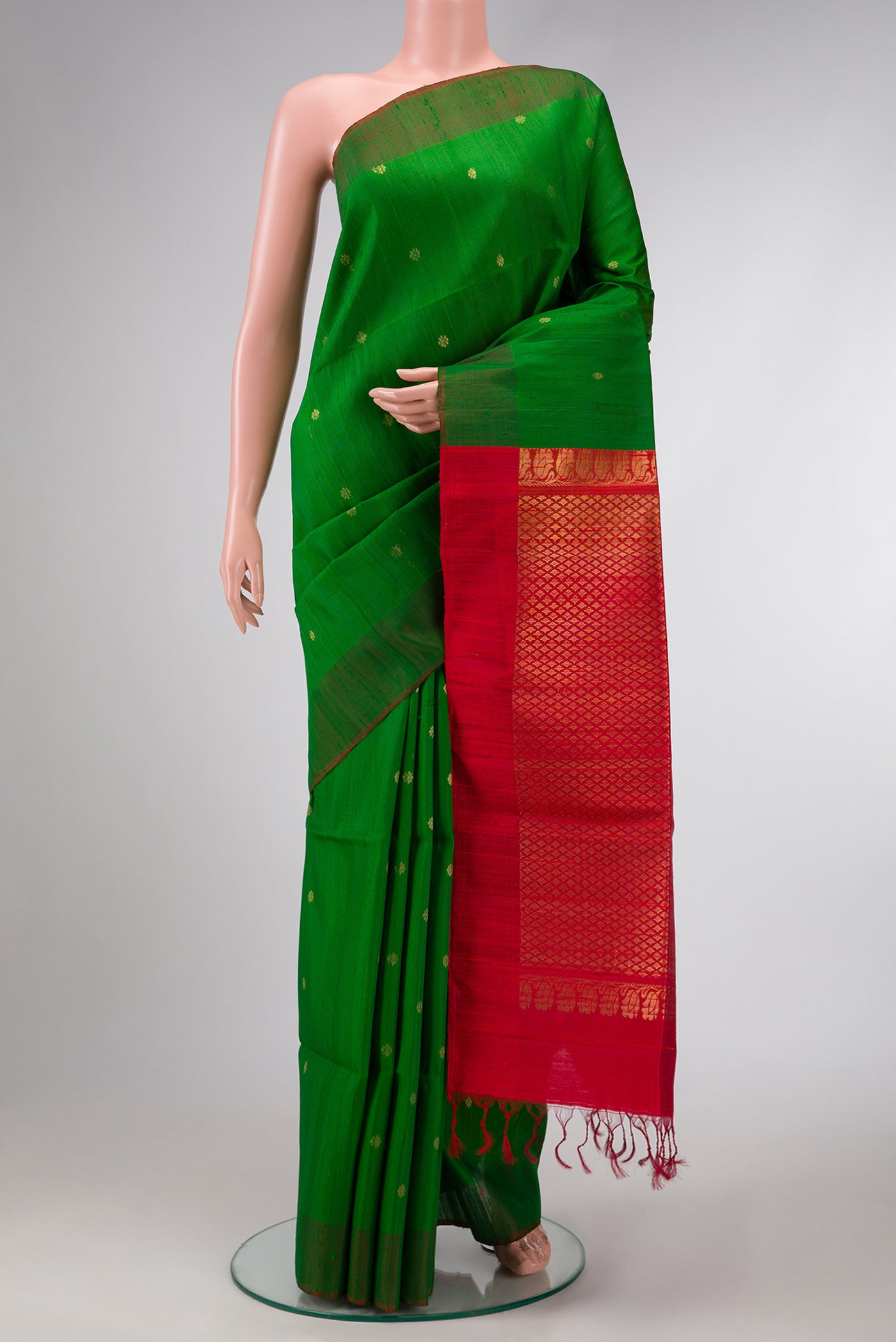 Green Dual Tone Raw Silk Saree with Zari Butta on the body and Plain Border.  displayed on a mannequin