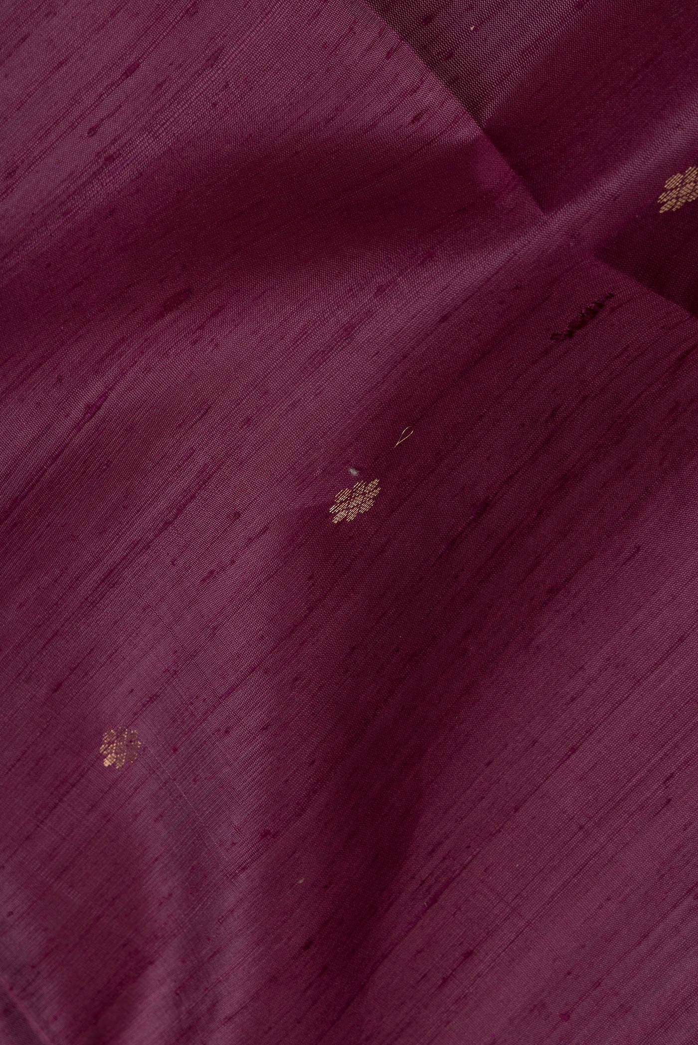 Close up of Purple Dual Tone Raw Silk Saree with Zari Butta on the body and Plain Border.  displaying folds