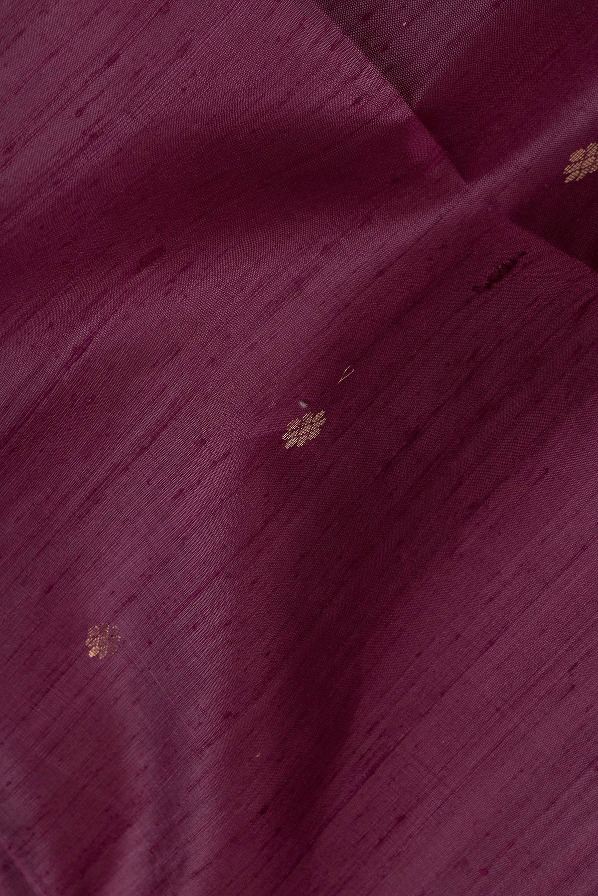 Close up of Purple Dual Tone Raw Silk Saree with Zari Butta on the body and Plain Border.  displaying folds