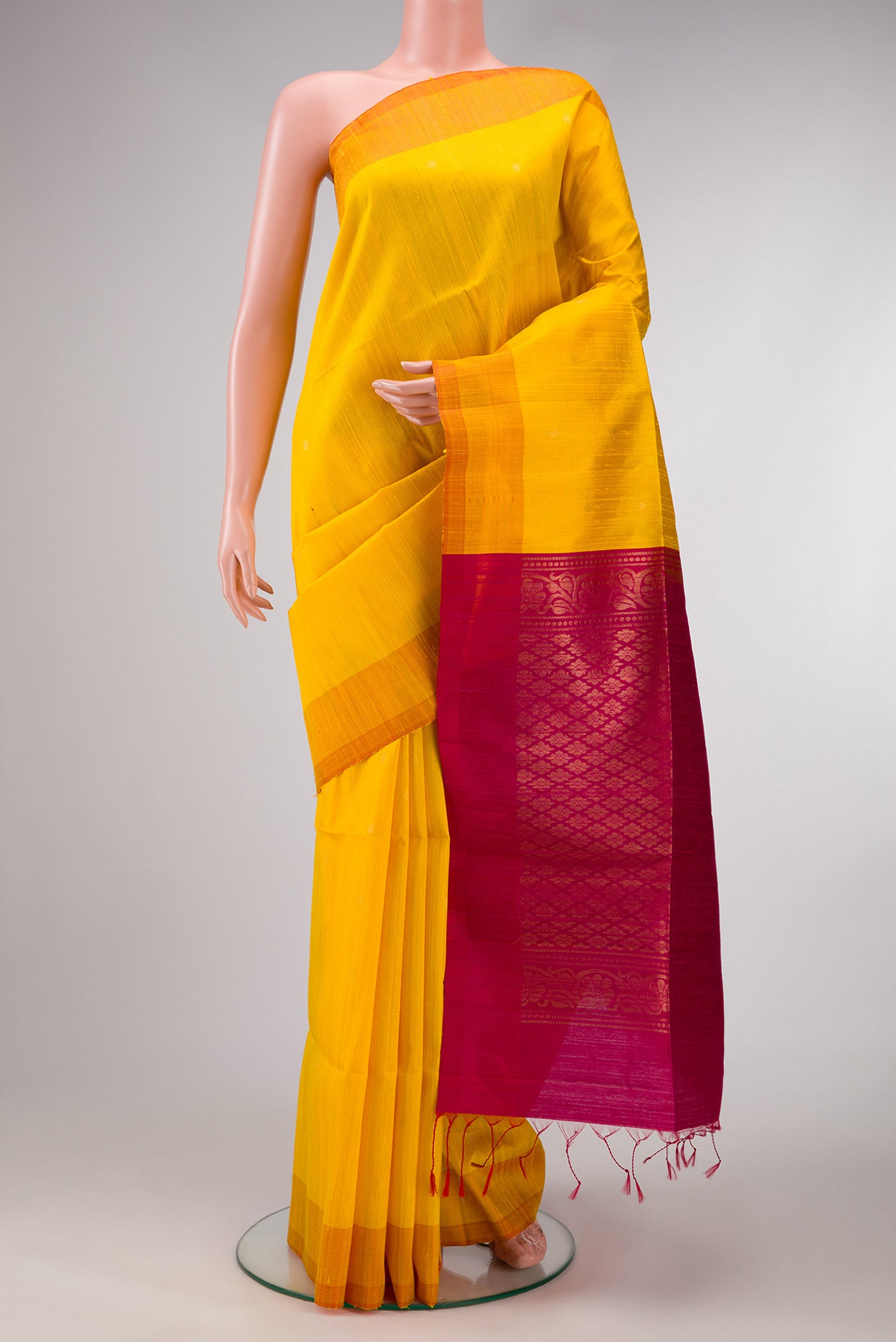 Yellow Dual Tone Raw Silk Saree with Zari Butta on the body and Plain Border.  displayed on a mannequin