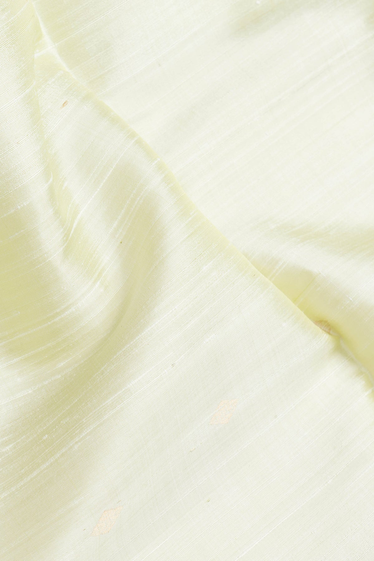 Close up of Pista Green Dual Tone Raw Silk Saree with Zari Butta on the body and Zari Border.  displaying folds