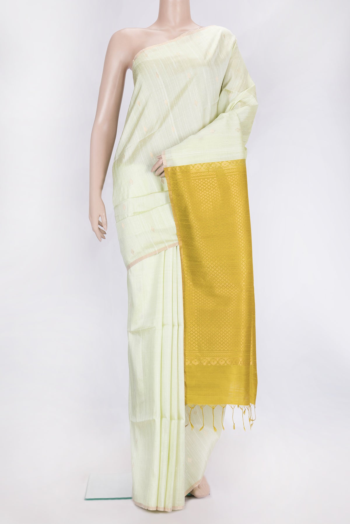 Pista Green Dual Tone Raw Silk Saree with Zari Butta on the body and Zari Border.  displayed on a mannequin
