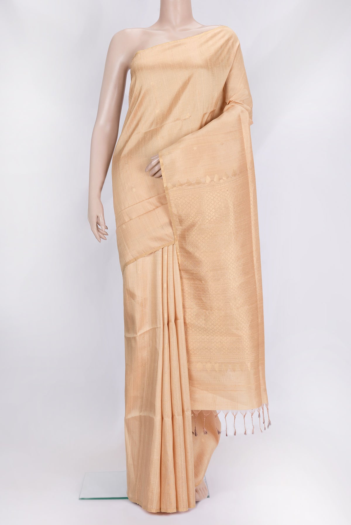 Beige Dual Tone Raw Silk Saree with Zari Butta on the body and Thin Zari Line.  displayed on a mannequin