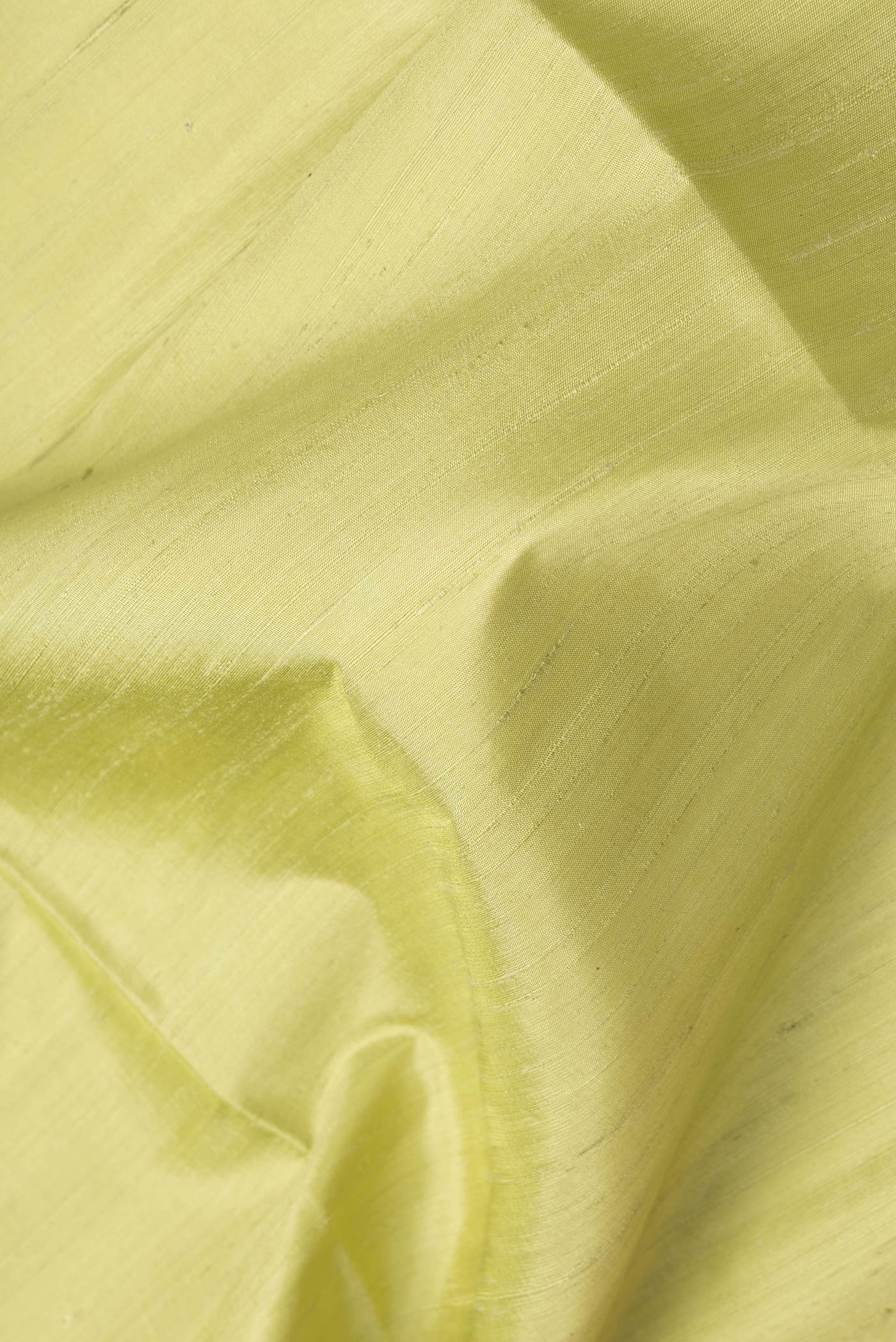 Close up of Pista Green Dual Tone Raw Silk Saree with Plain Body and Fancy Border.  displaying folds
