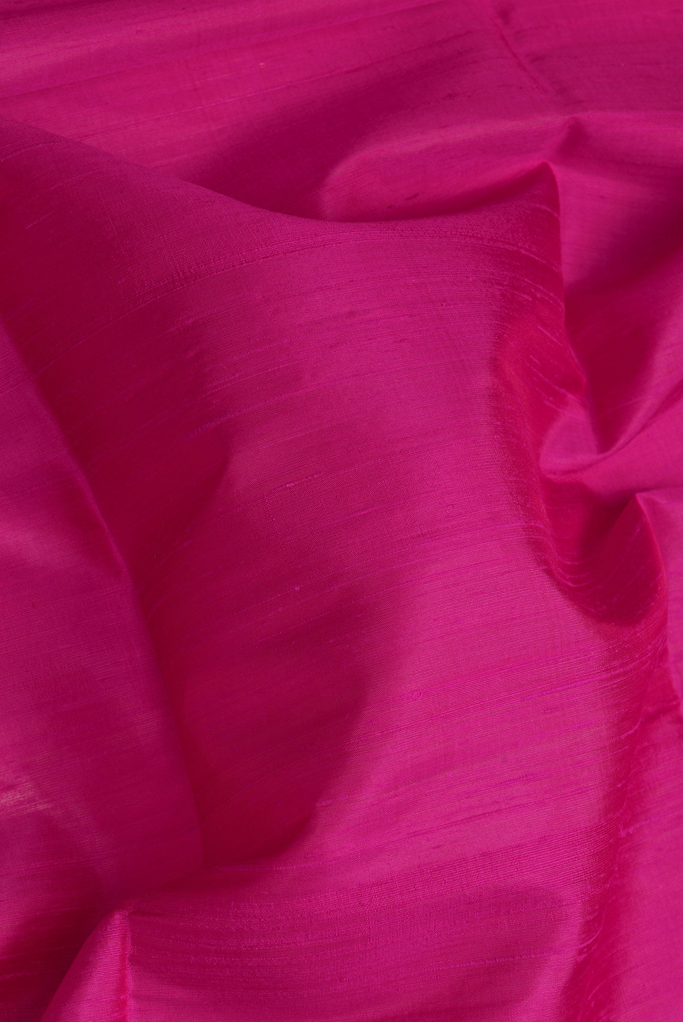 Close up of Pink Dual Tone Raw Silk Saree with Plain Body and Fancy Border.  displaying folds