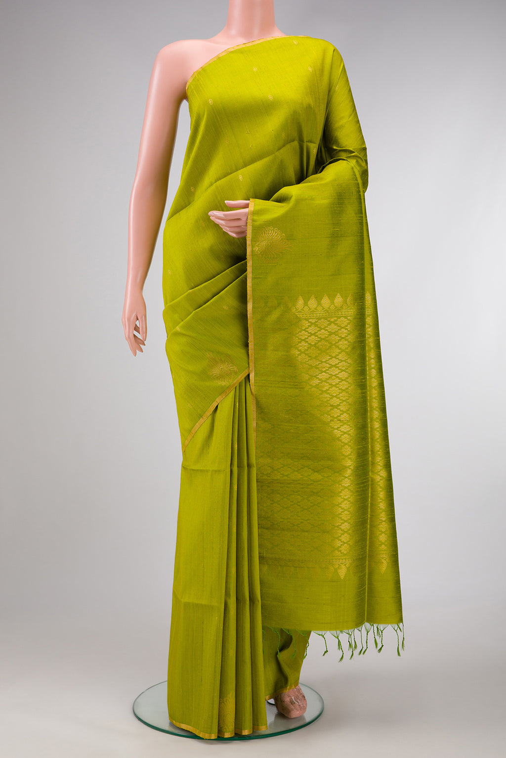 Parrot Green Dual Tone Raw Silk Saree with Zari Butta on the body and Fancy Border.  displayed on a mannequin