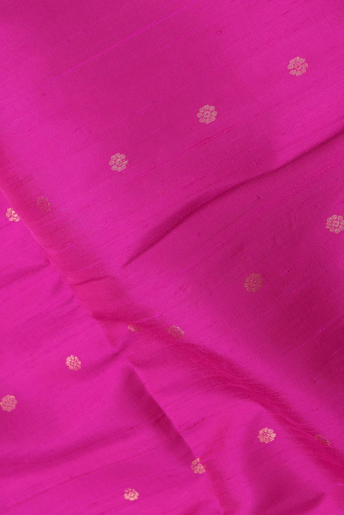 Close up of Pink Dual Tone Raw Silk Saree with Zari Butta on the body and Zari Border.  displaying folds